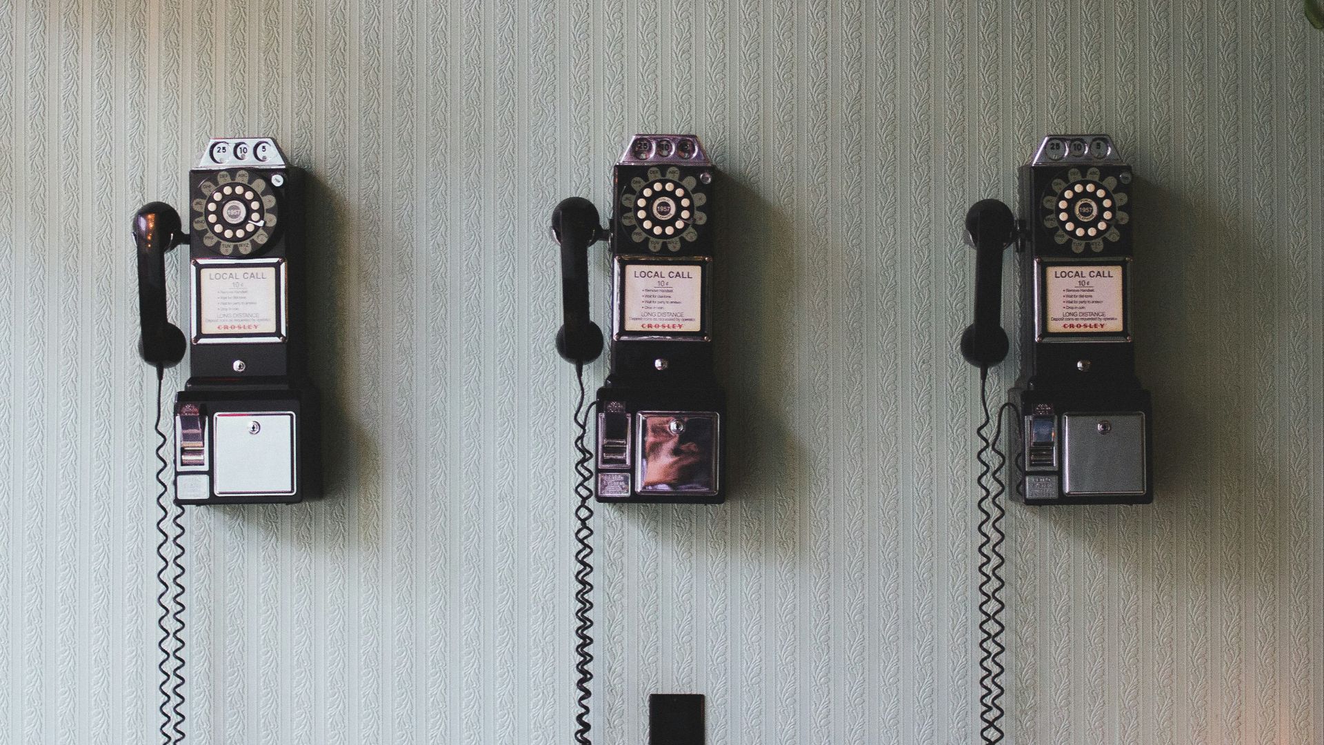 minimalist photography of three crank phones