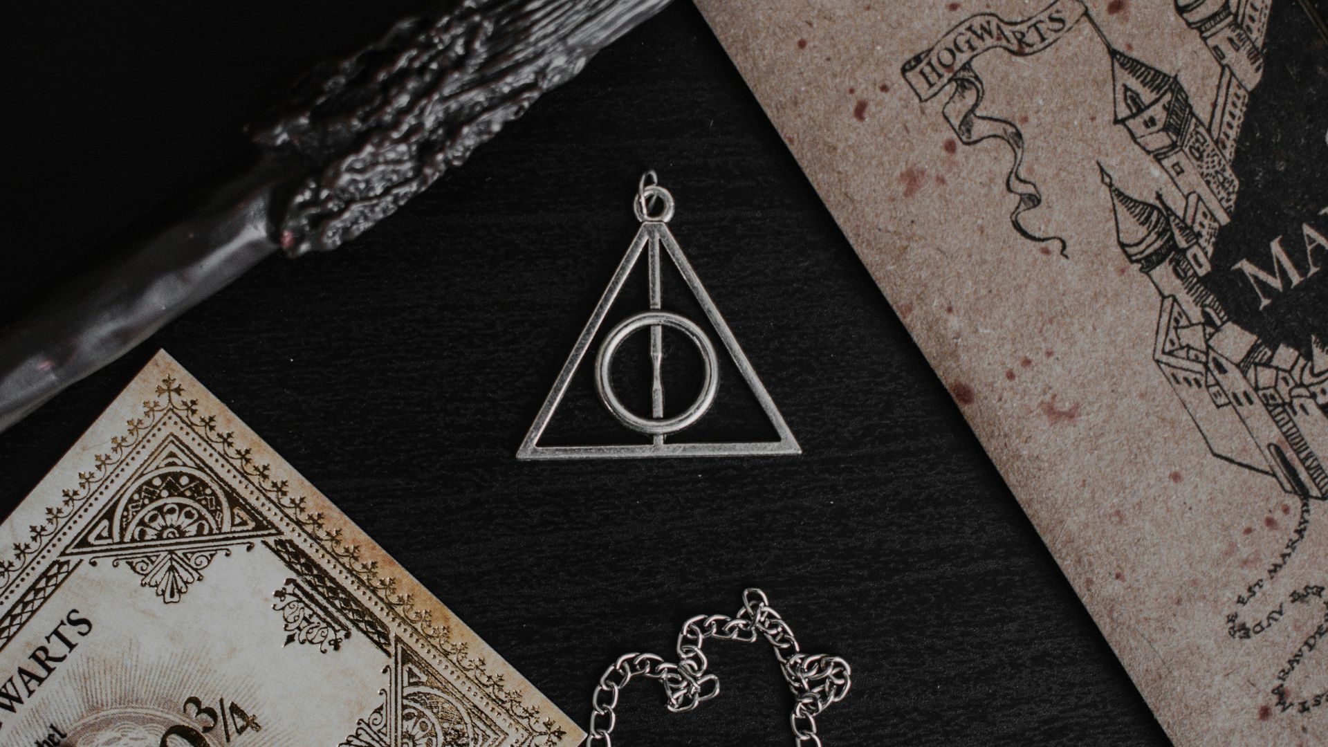 a harry potter necklace next to a money bill