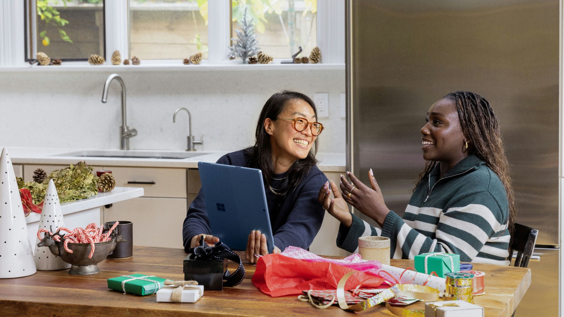 a woman sitting at a table in front of a window
