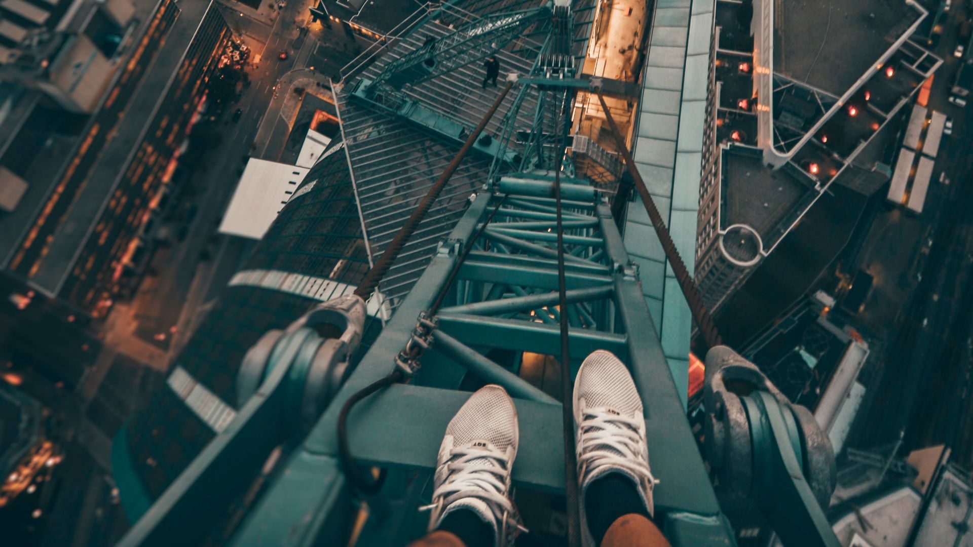 person standing on gray steel frame on top of building