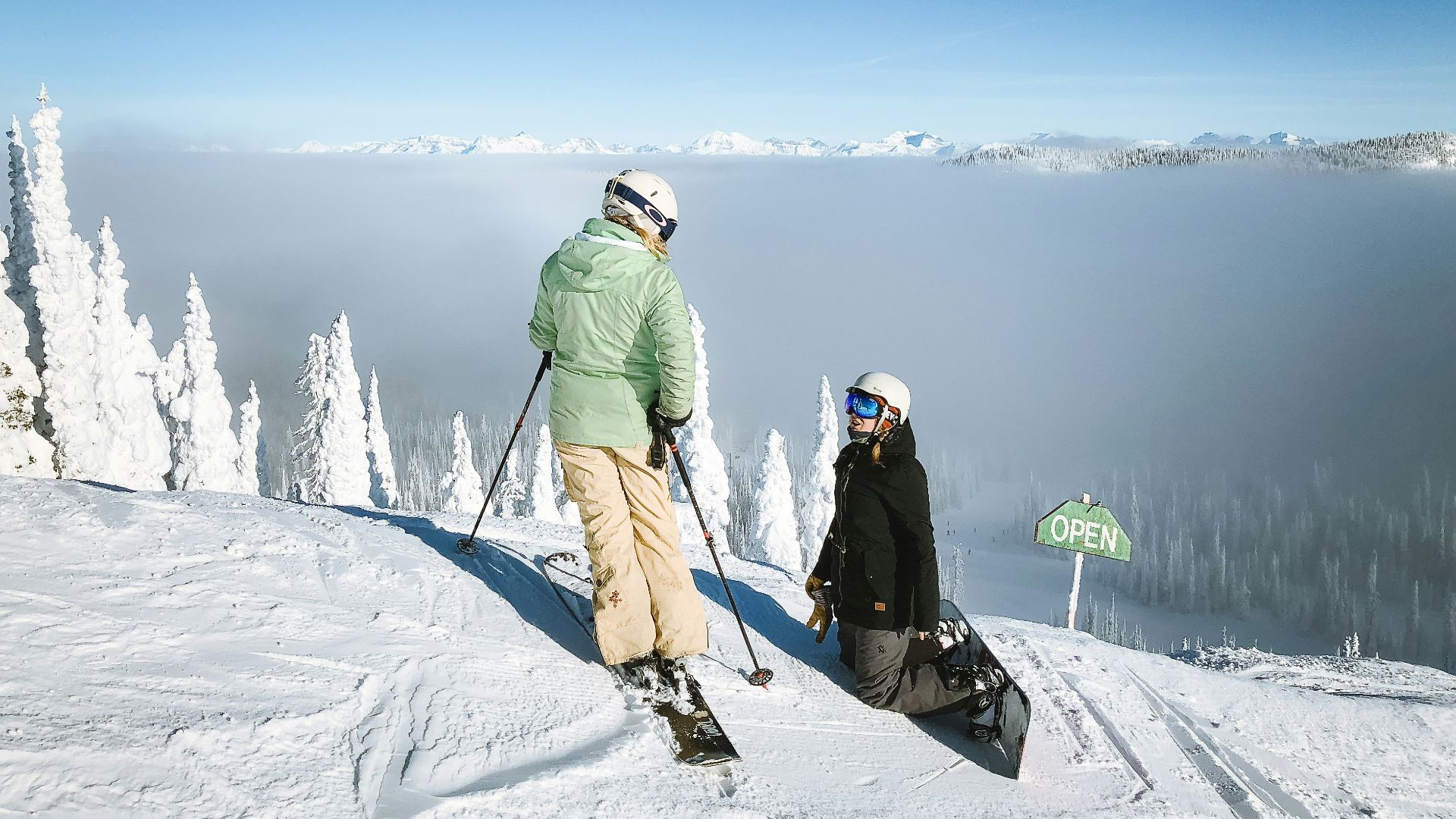man in green snow jacket and brown pants