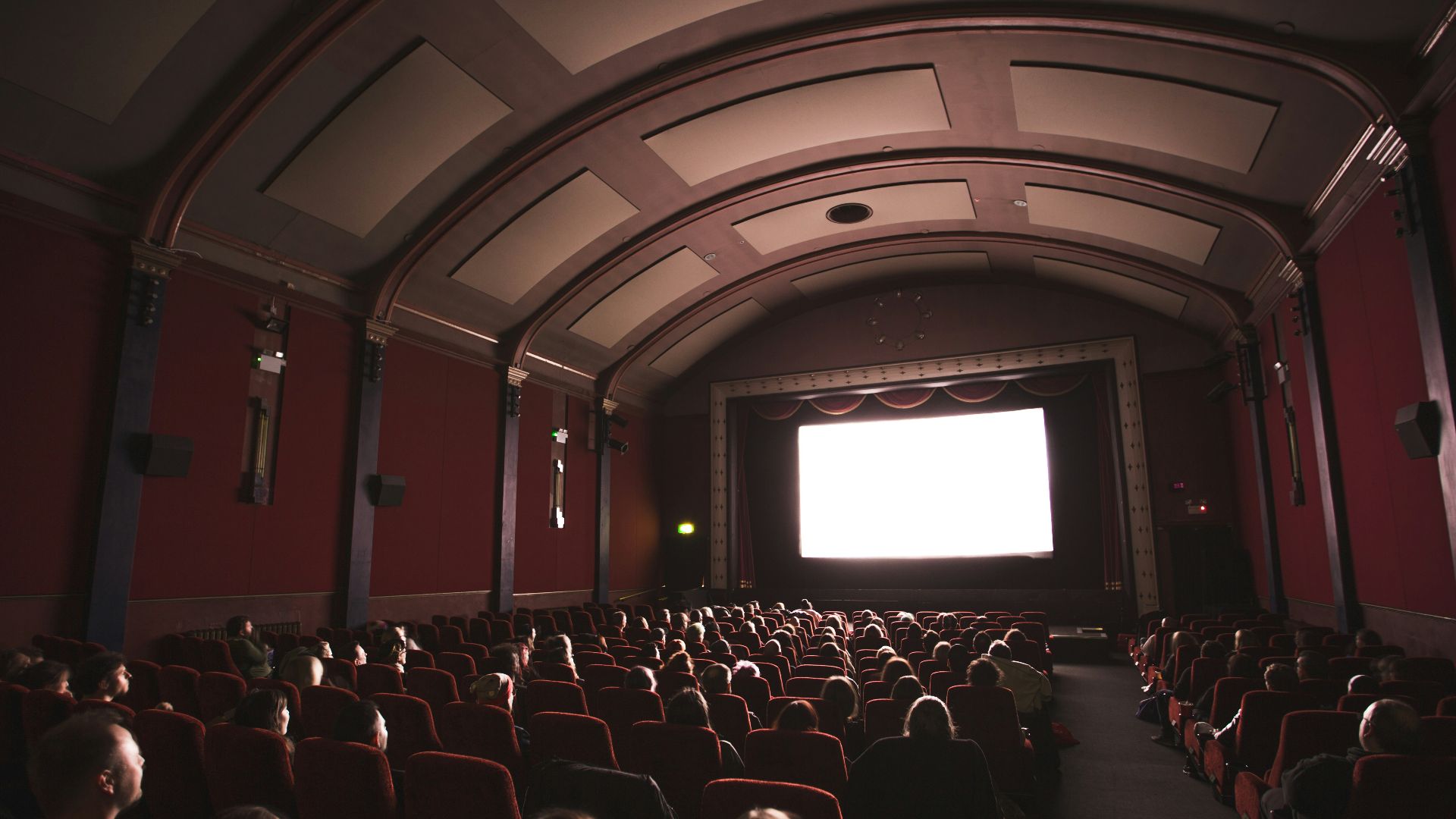 group of people staring at monitor inside room