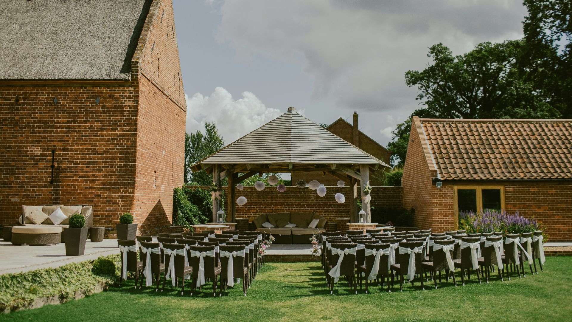 brown chair lot arranged in front of gazebo and house