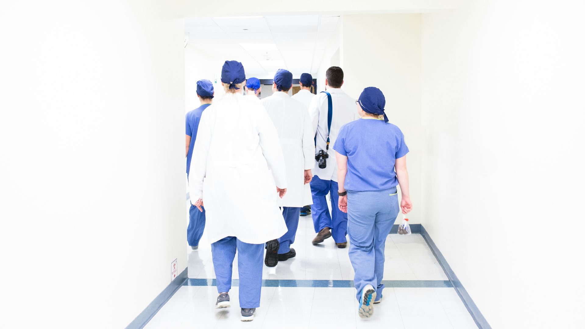 group of doctors walking on hospital hallway