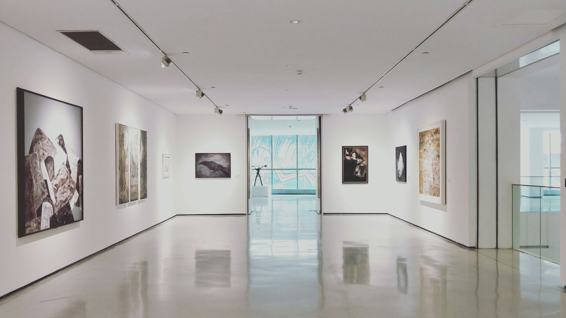 assorted paintings on white painted wall