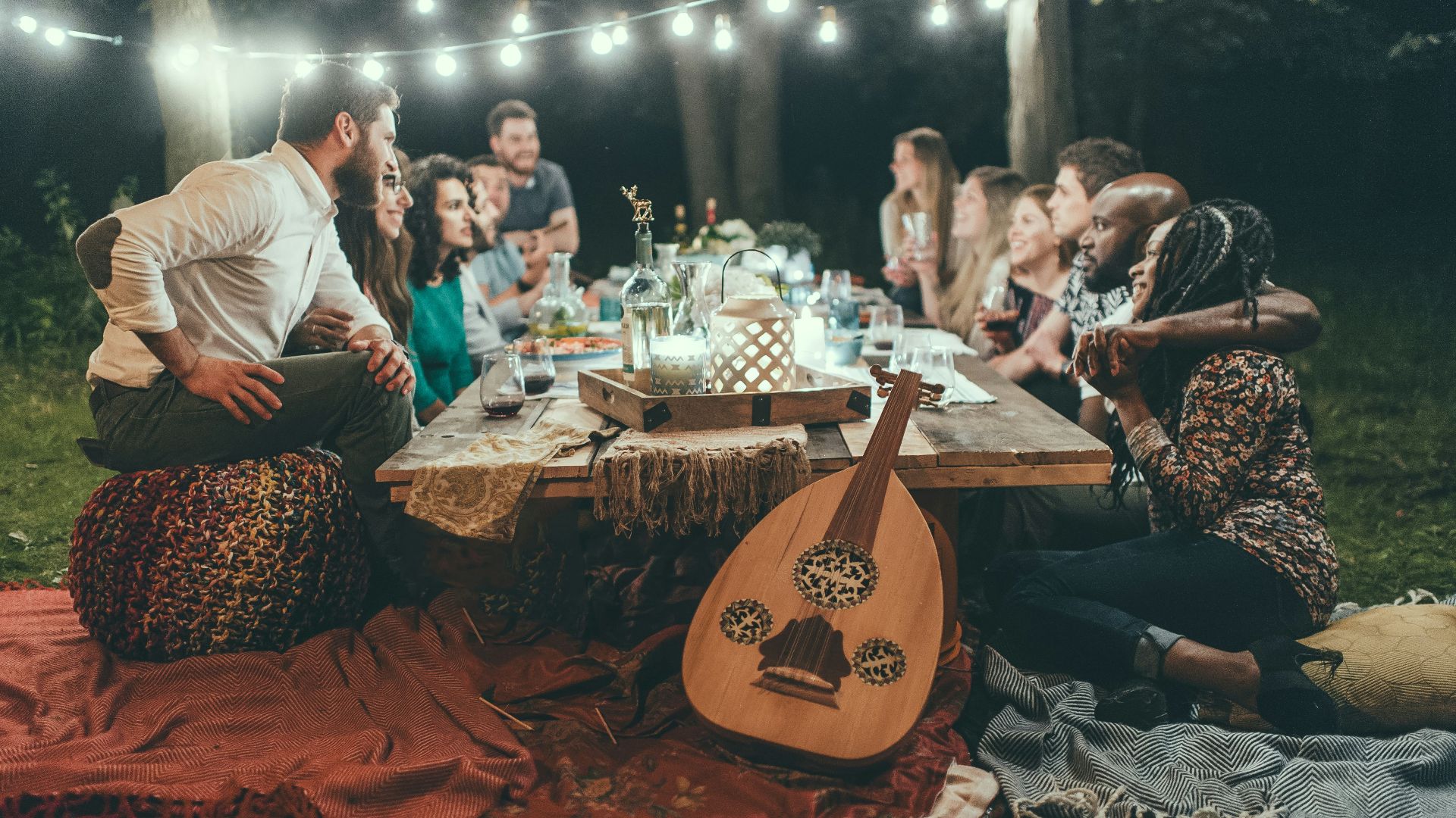 people sitting on chair in front of table with candles and candles