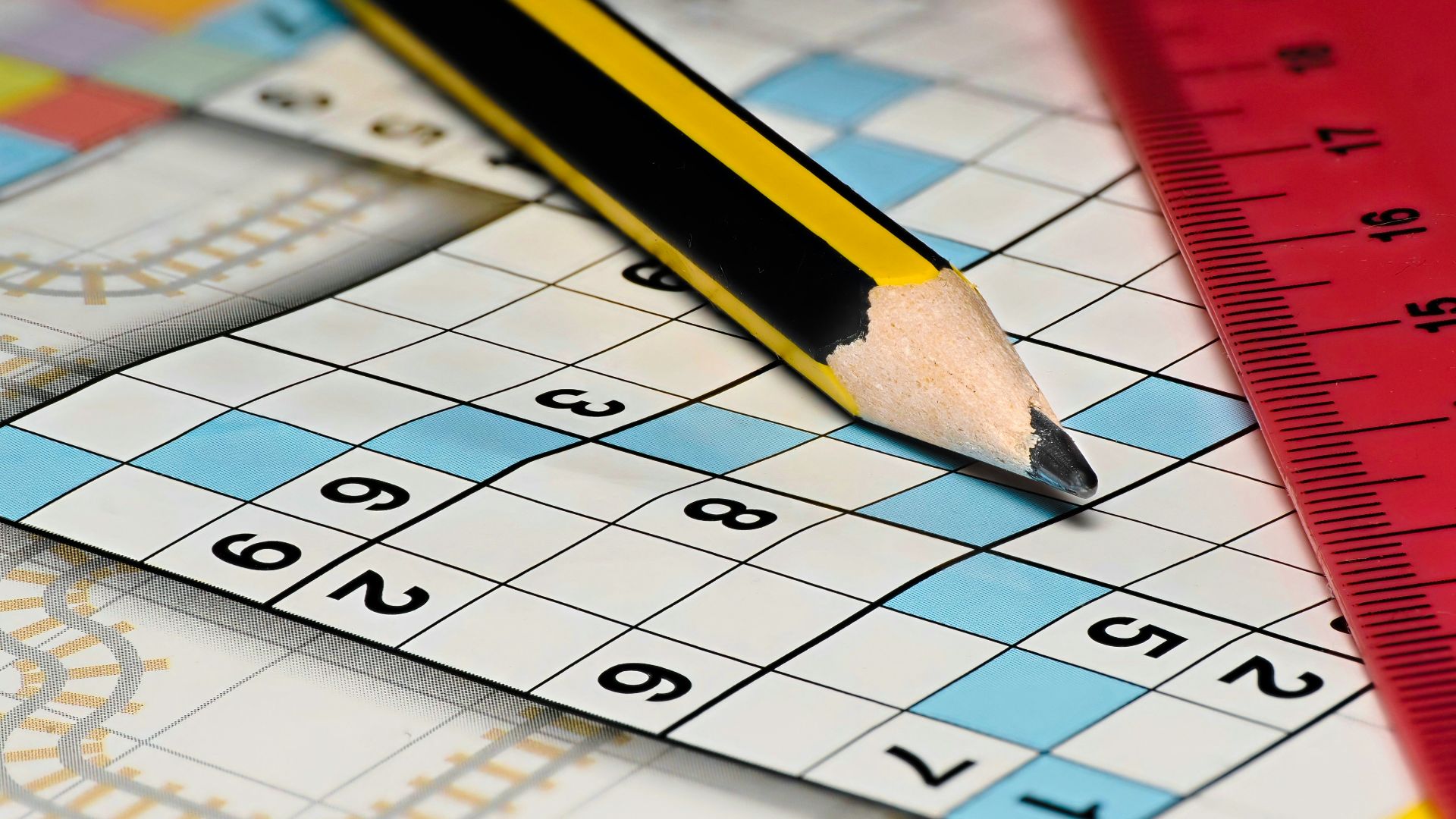A pencil sitting on top of a piece of paper next to a ruler