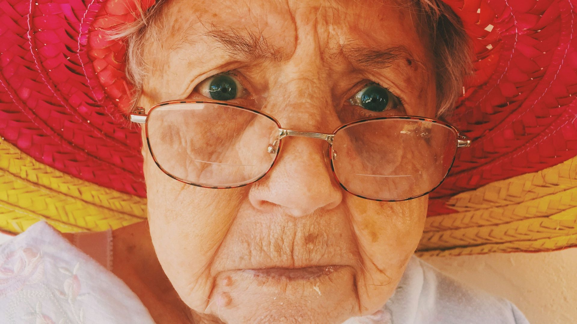 woman in white top wearing eyeglasses