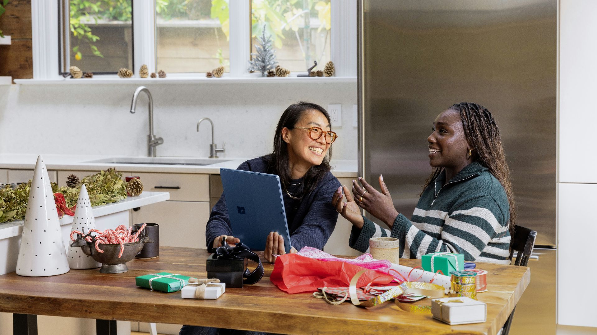 a woman sitting at a table in front of a window