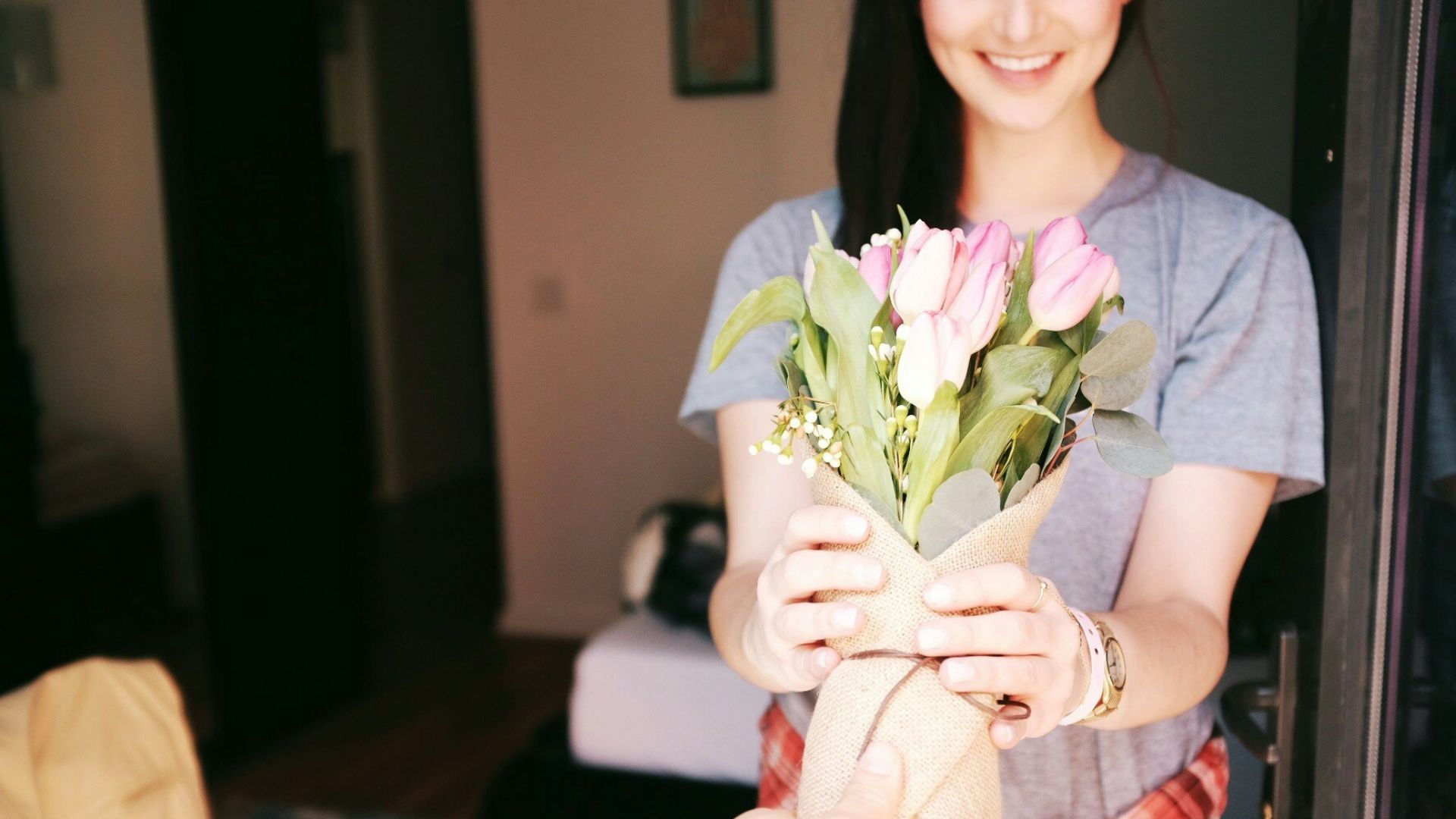 woman holding flower bouquets