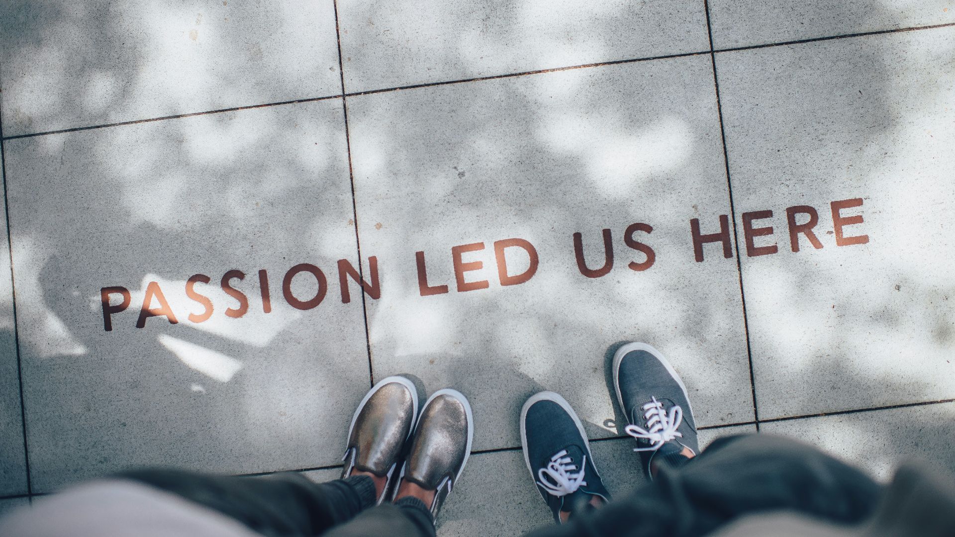 two person standing on gray tile paving
