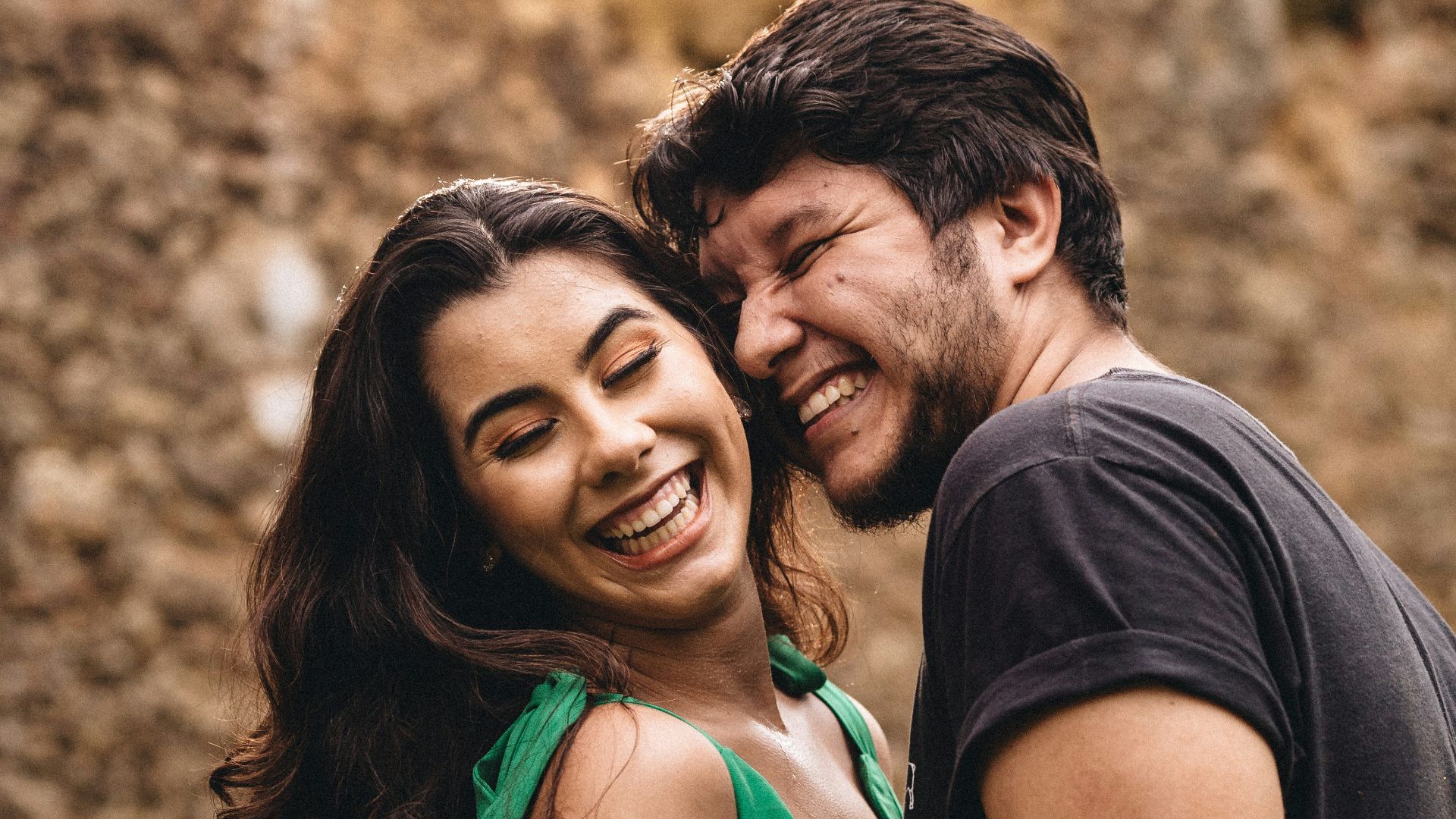 man in black crew neck shirt beside woman in green tank top