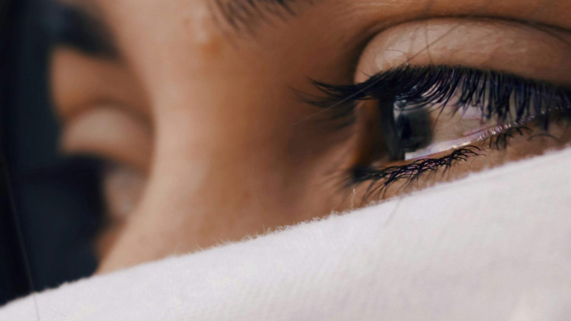 shallow focus of a woman's sad eyes