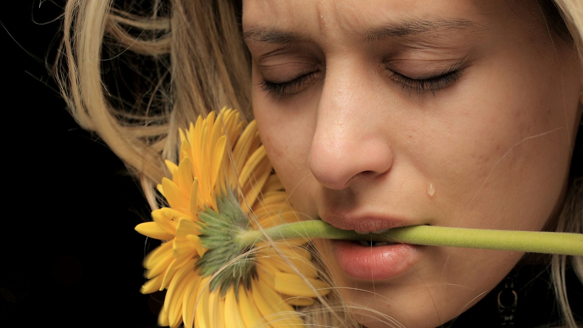 woman in black shirt with yellow hair