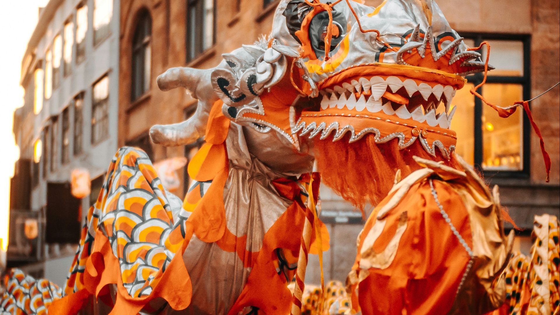 people in orange and white costume walking on street during daytime