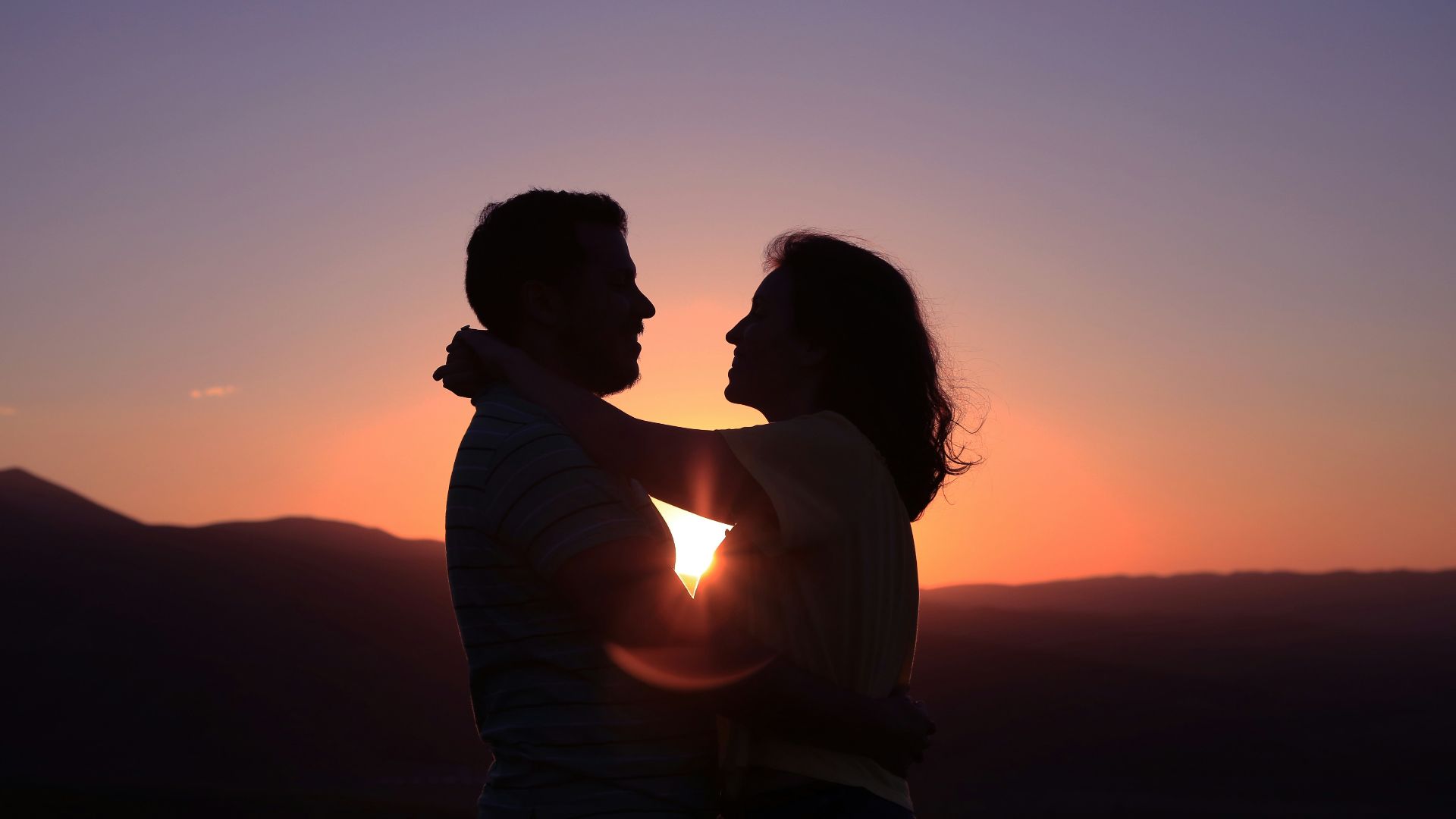 silhouette of hugging couple