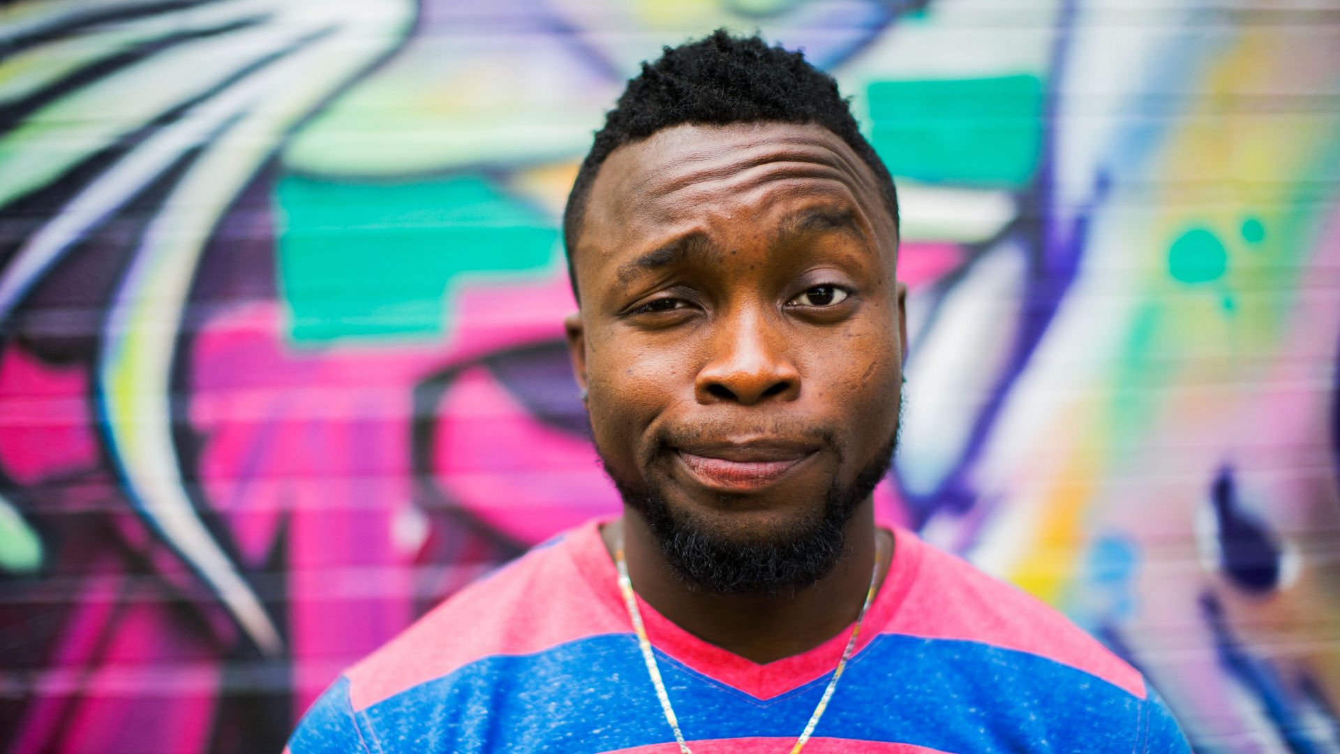 black haired man making face