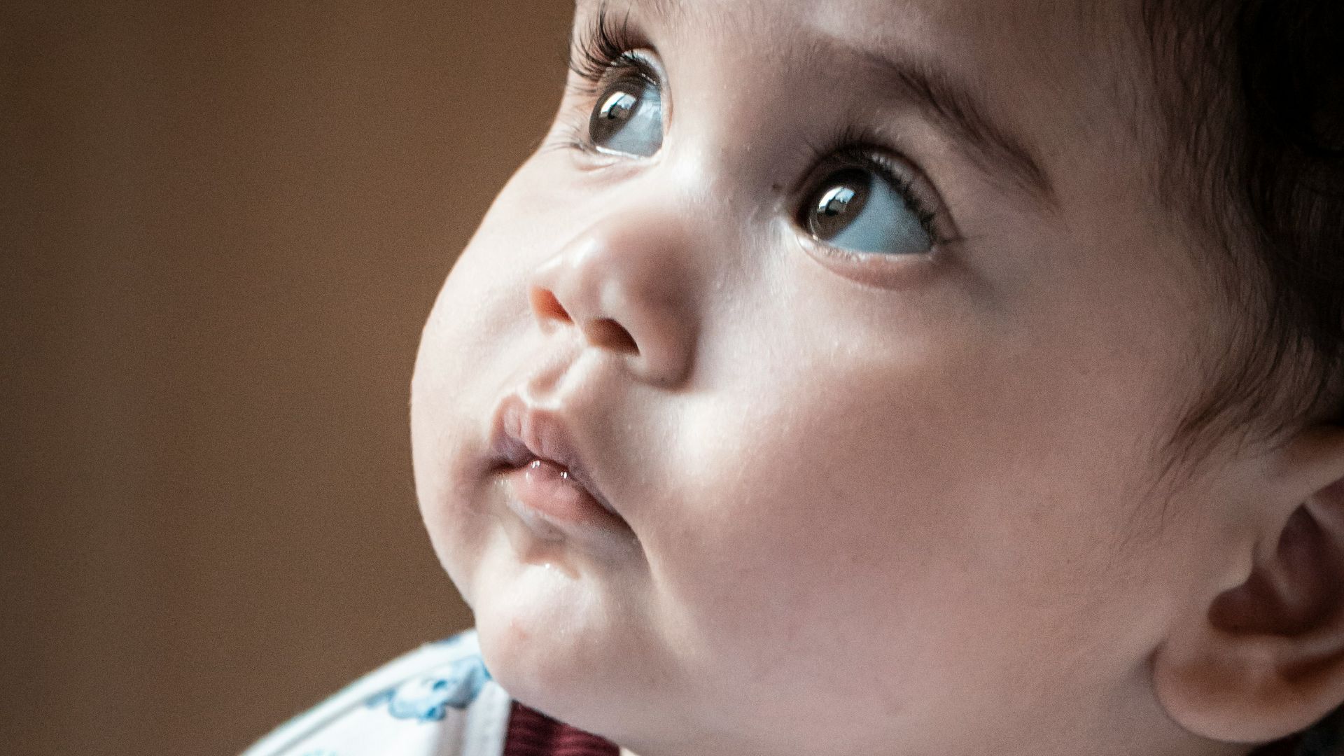child in white red and blue crew neck shirt