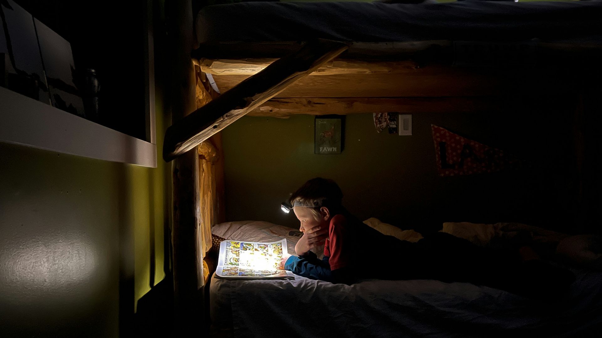 man in red shirt lying on bed