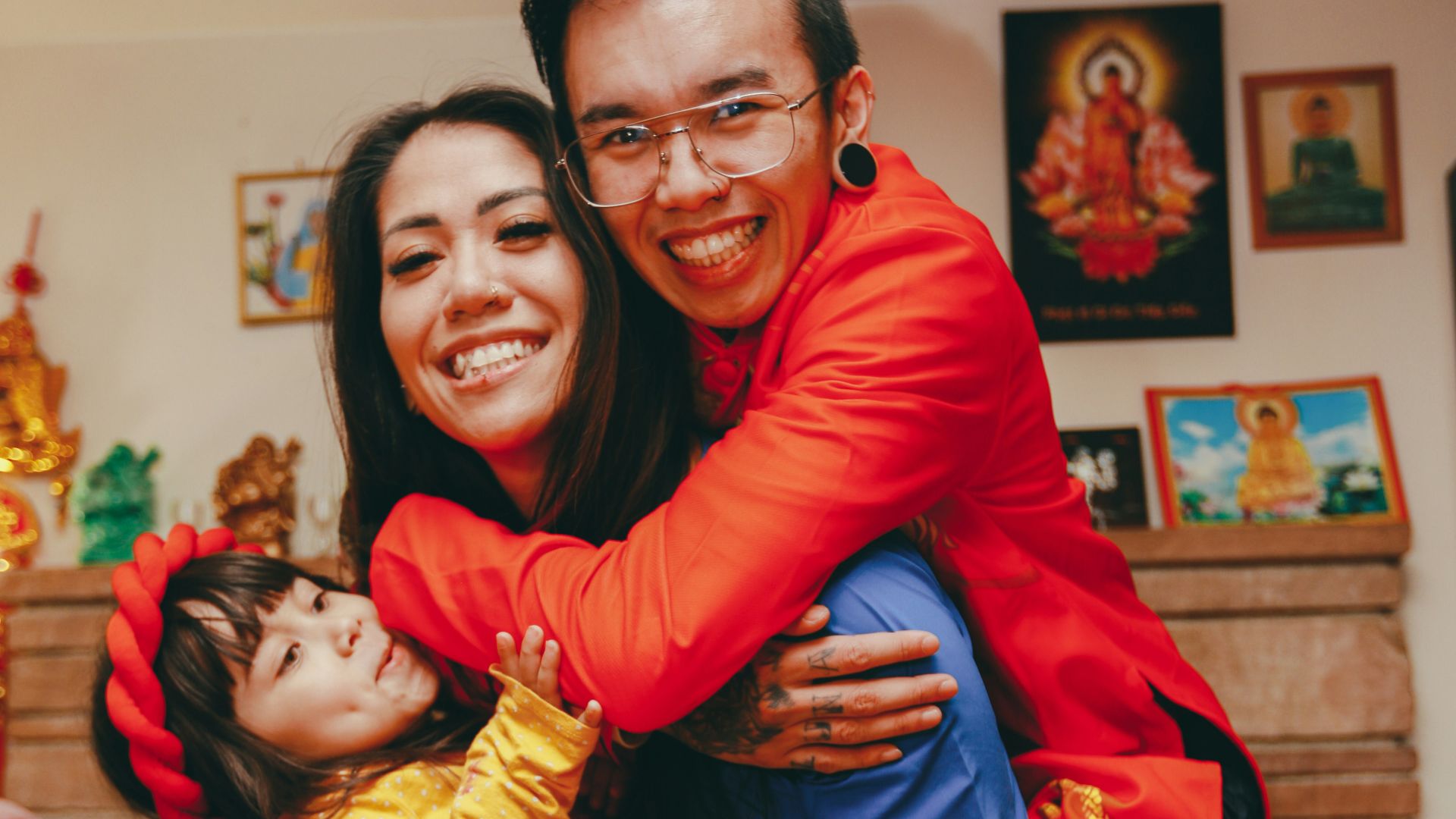 a man and a woman holding a child in their arms