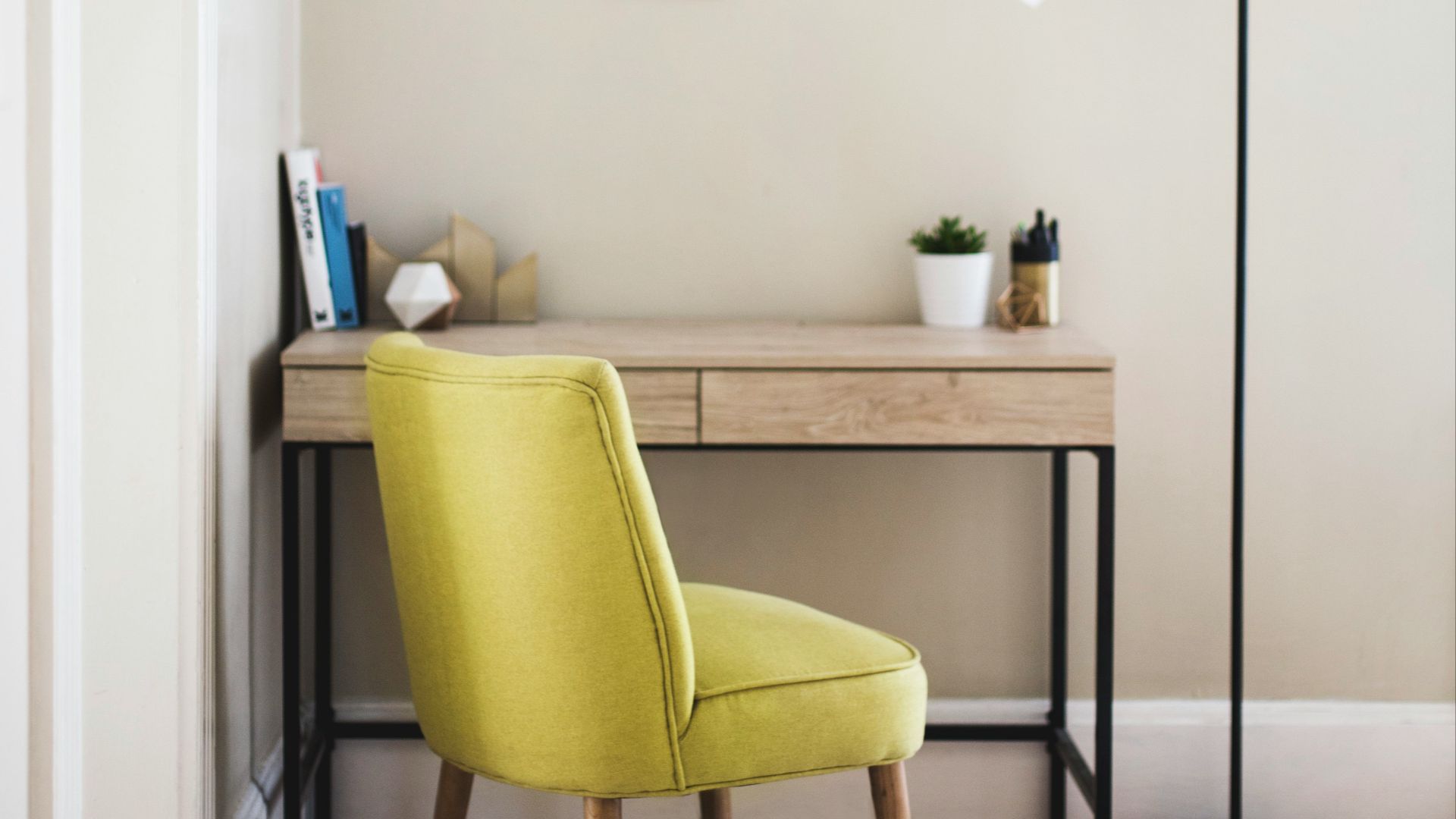 black 2-light torchiere beside brown wooden-top desk with black steel frame