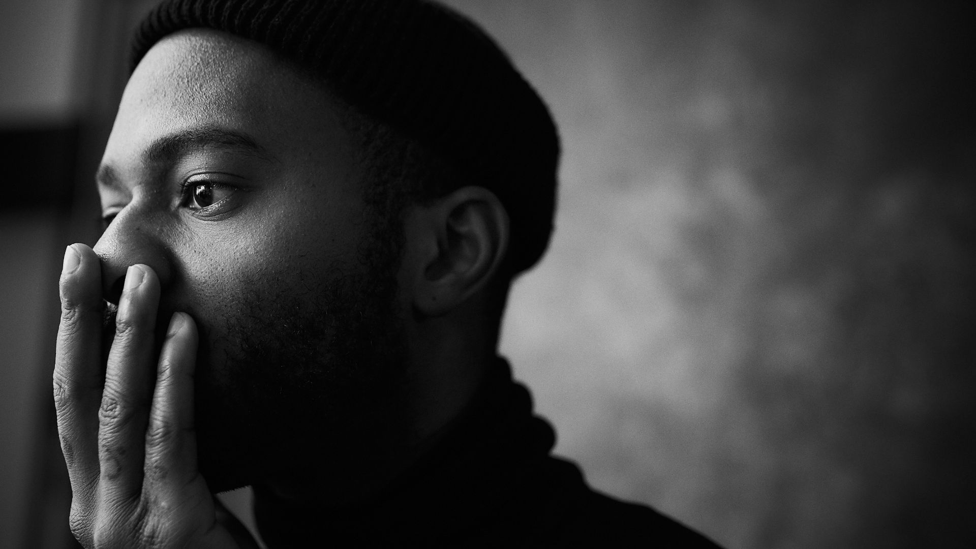 man in knit cap grayscale photo