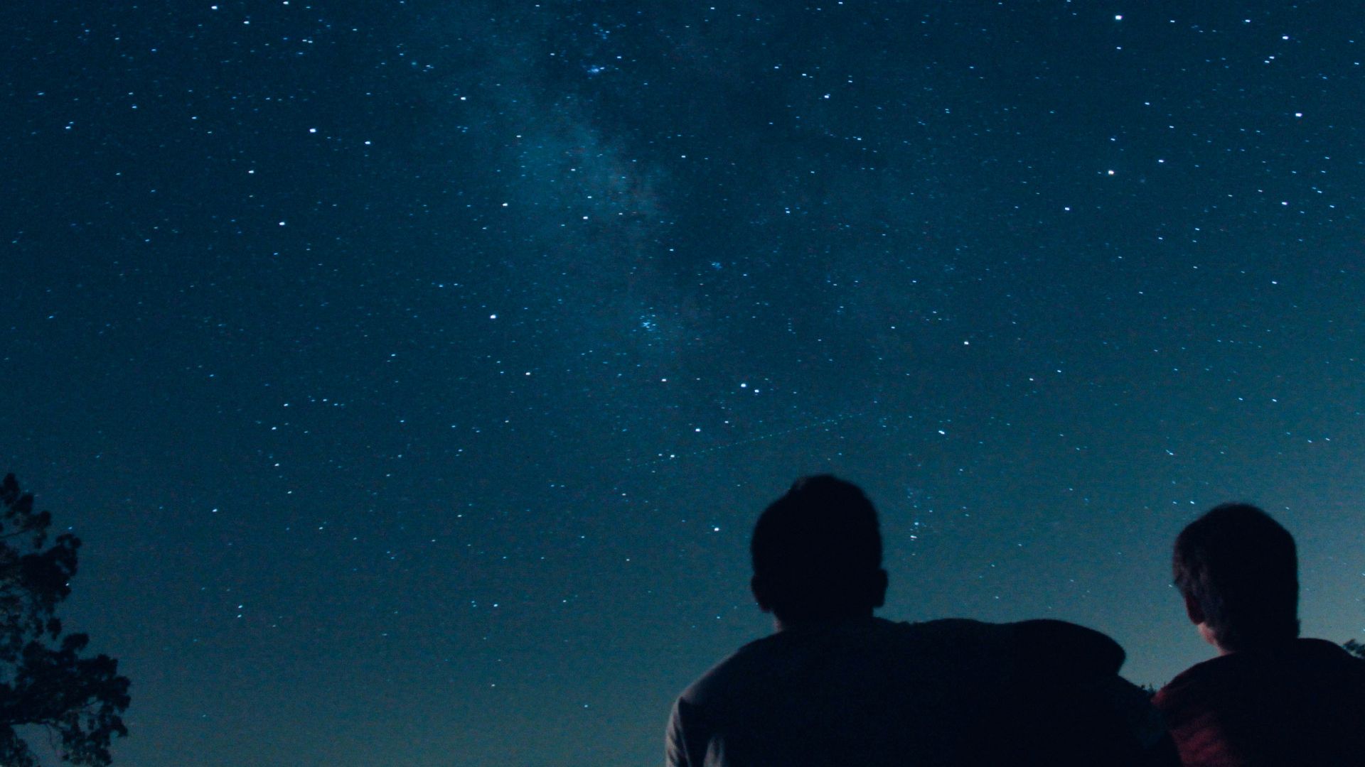 silhouette photo of two person watching stars