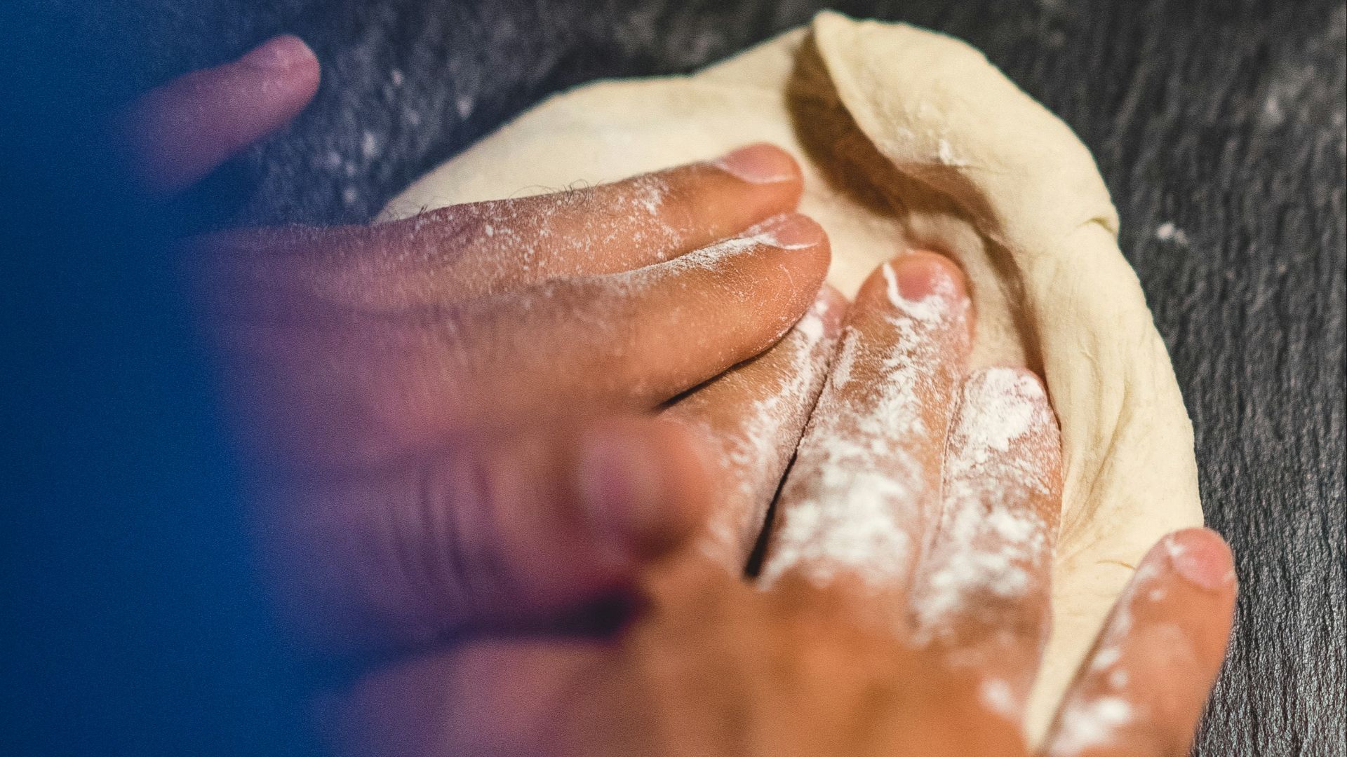 a person is kneading dough on a table