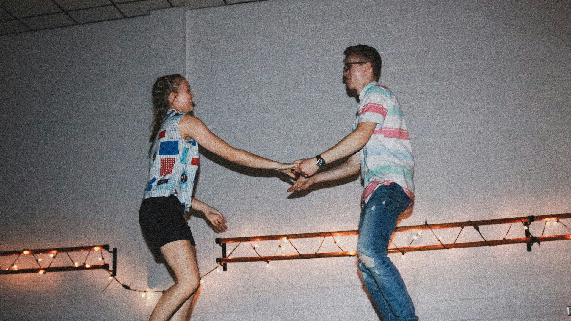 woman and man standing near wall