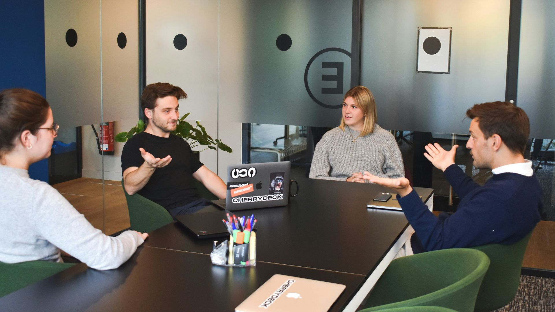 woman in black long sleeve shirt sitting beside woman in gray long sleeve shirt