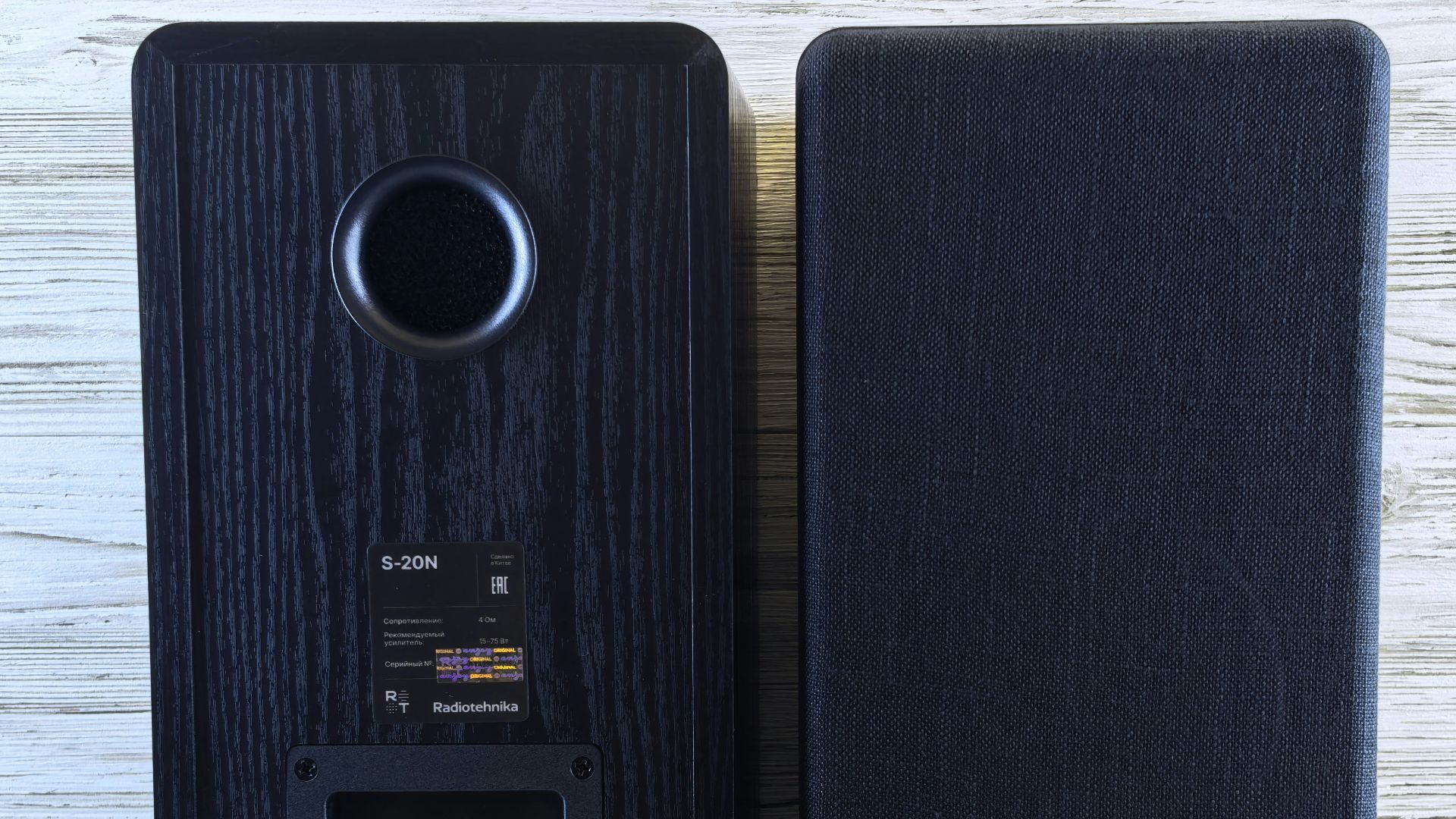 Two black speakers shown from the back and front.