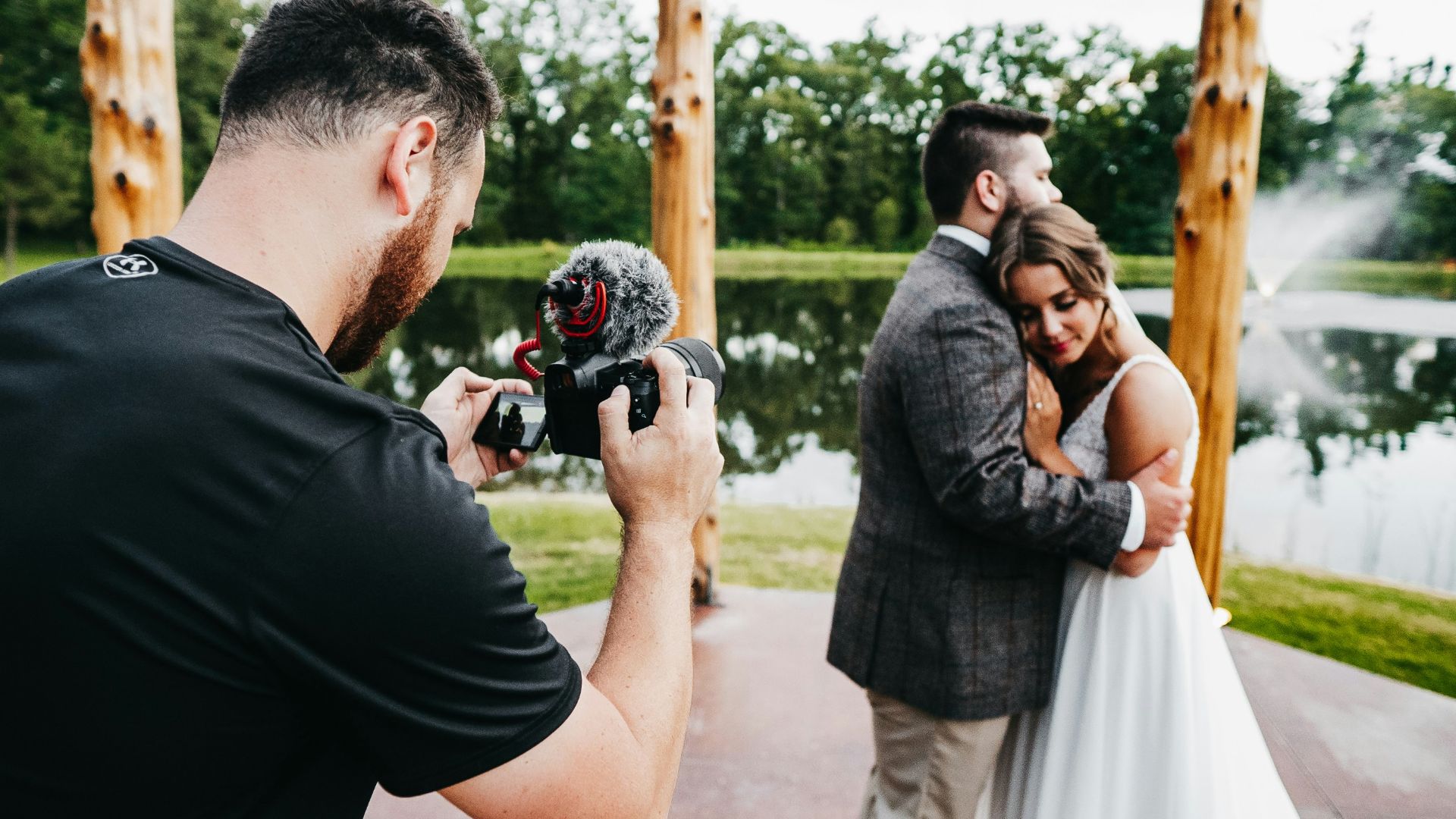 man in black t-shirt holding black dslr camera