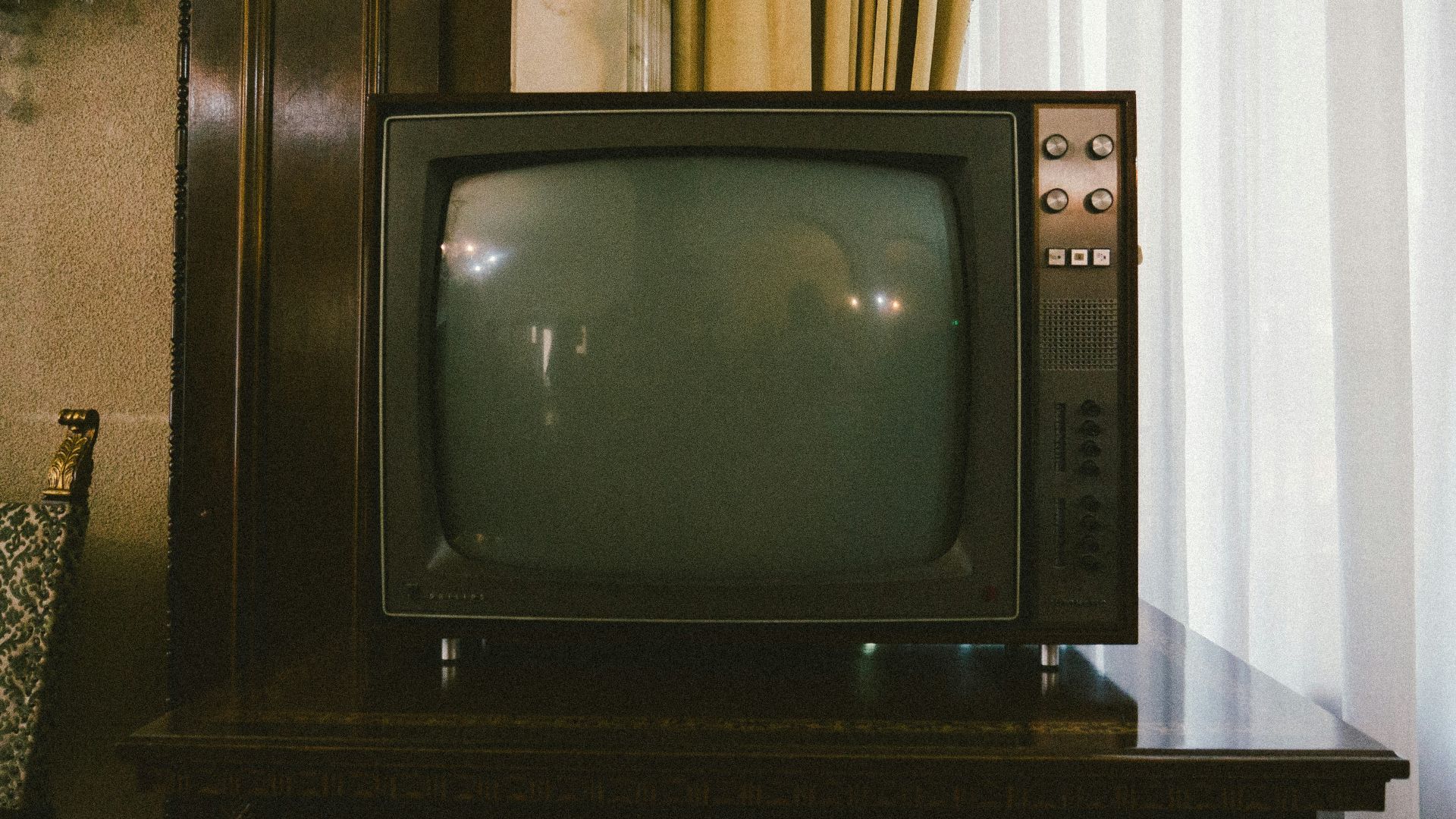 turned-off gray CRT TV on table