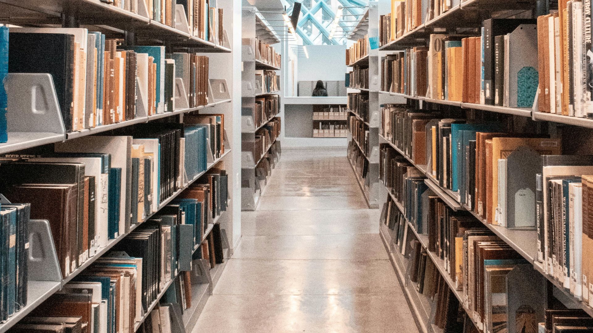 brown wooden book shelves in library