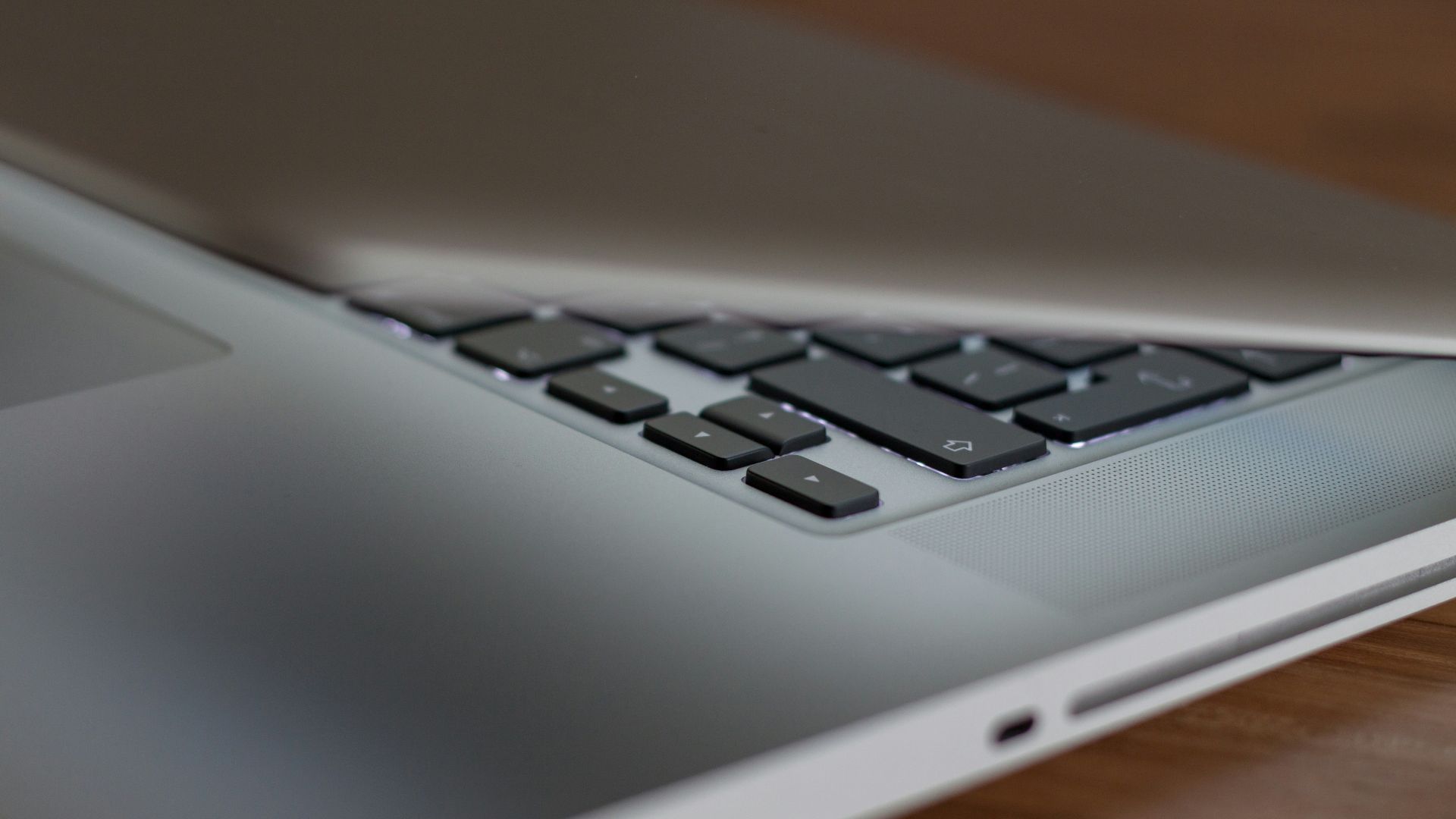 a laptop computer sitting on top of a wooden table