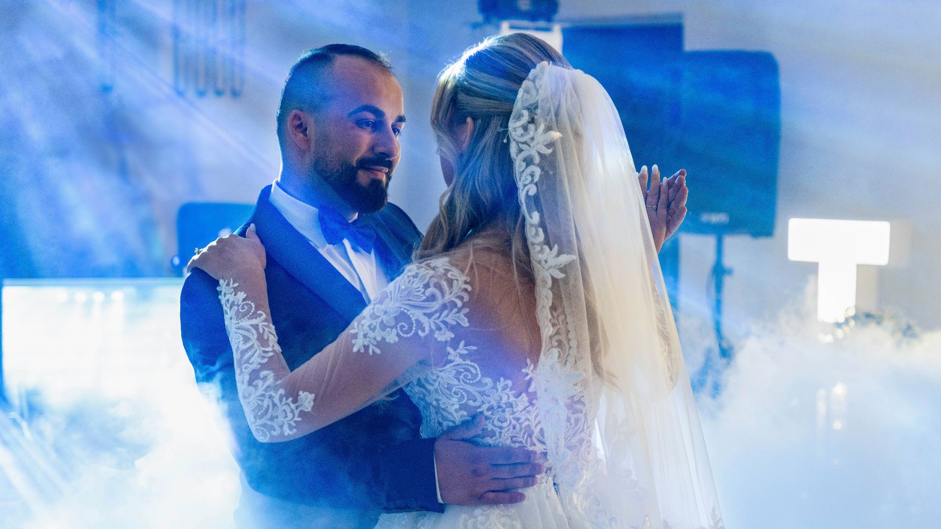 A bride and groom dancing in a cloud of smoke