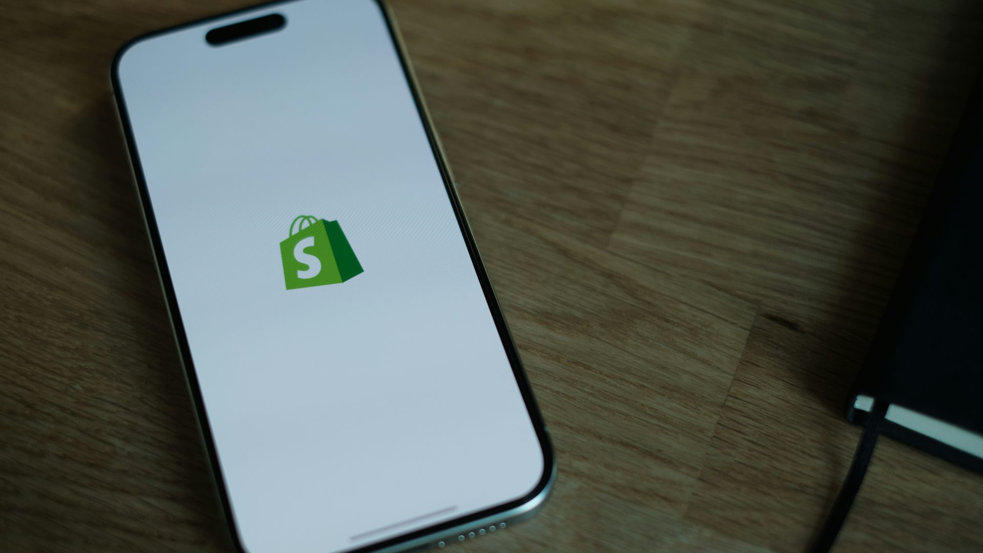A cell phone sitting on top of a wooden table
