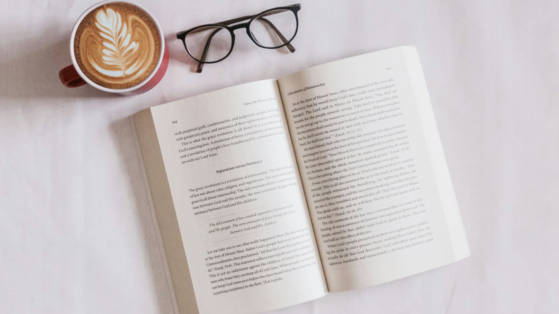 book near eyeglasses and cappuccino