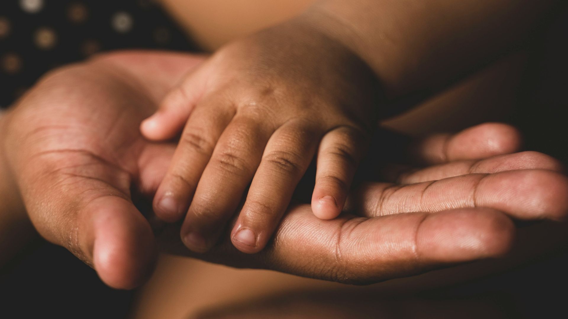a close up of a person holding their hands together