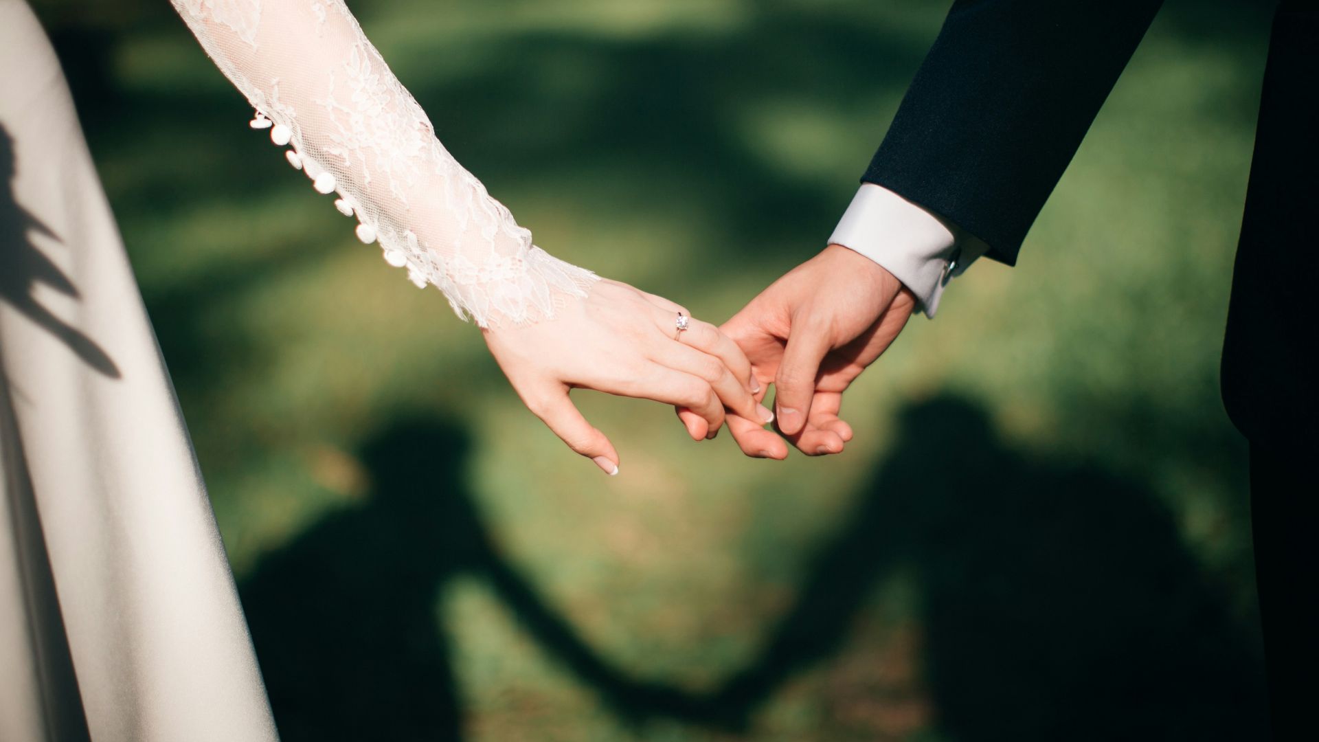 man and woman holding hands focus photo