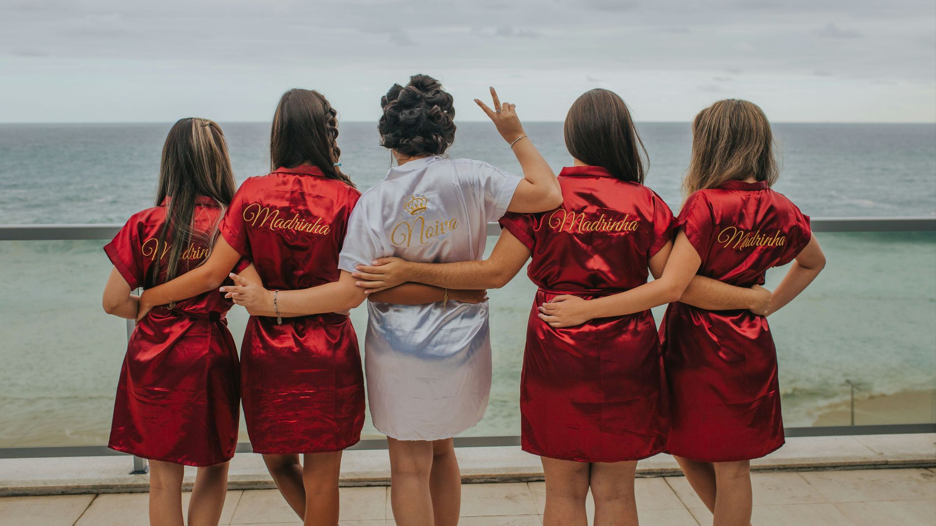 brides and bridesmaid looking at the back