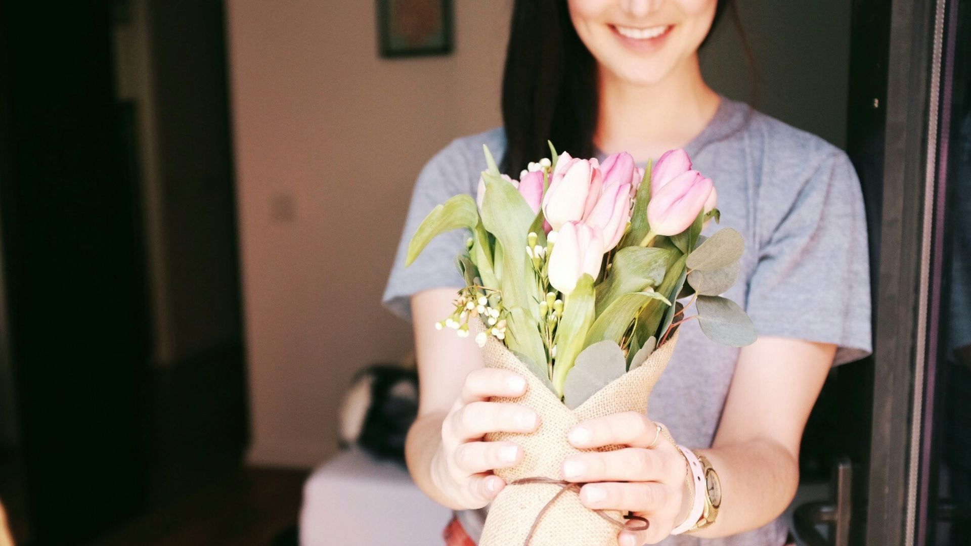 woman holding flower bouquets