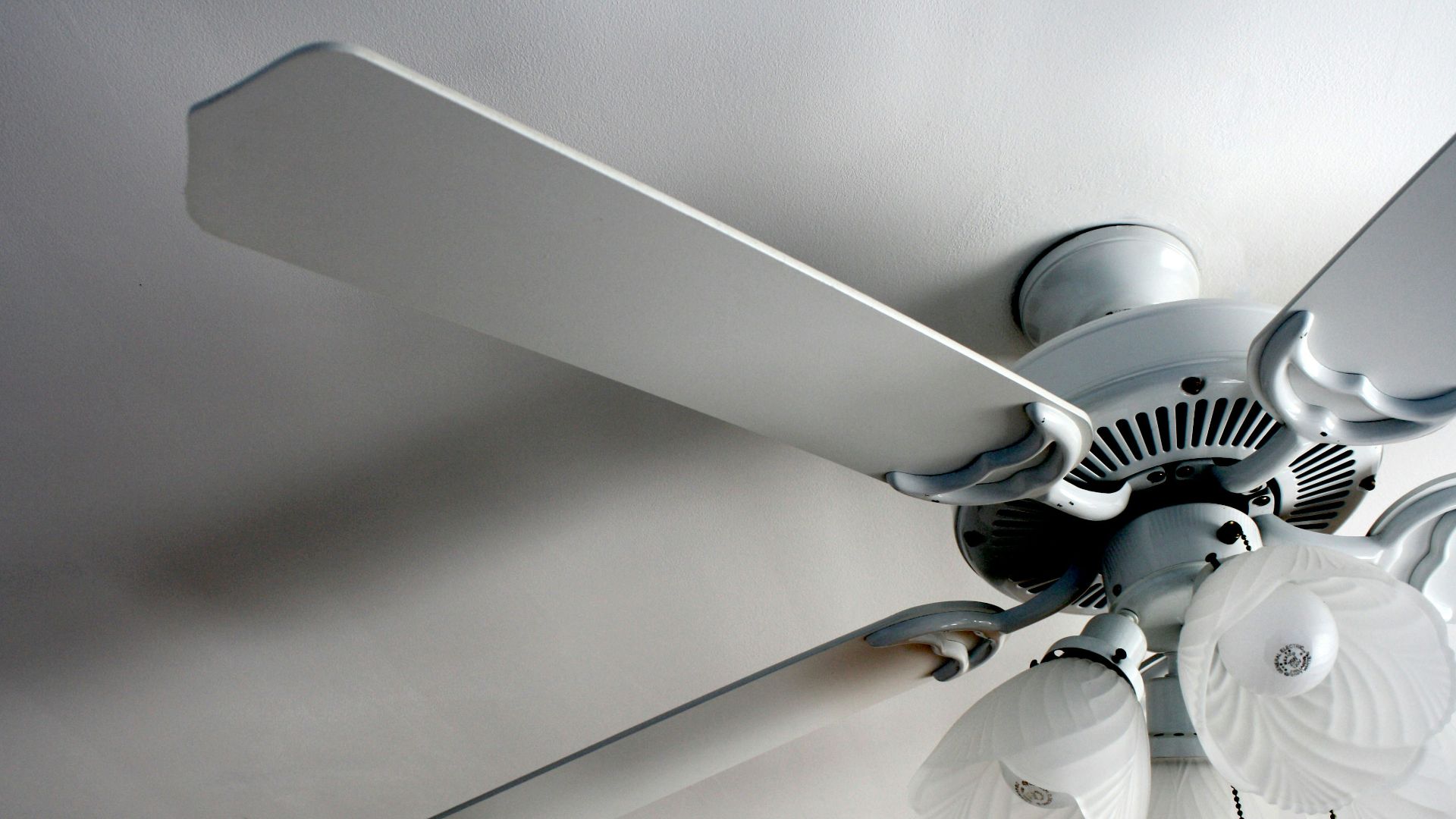a white ceiling fan in a white room