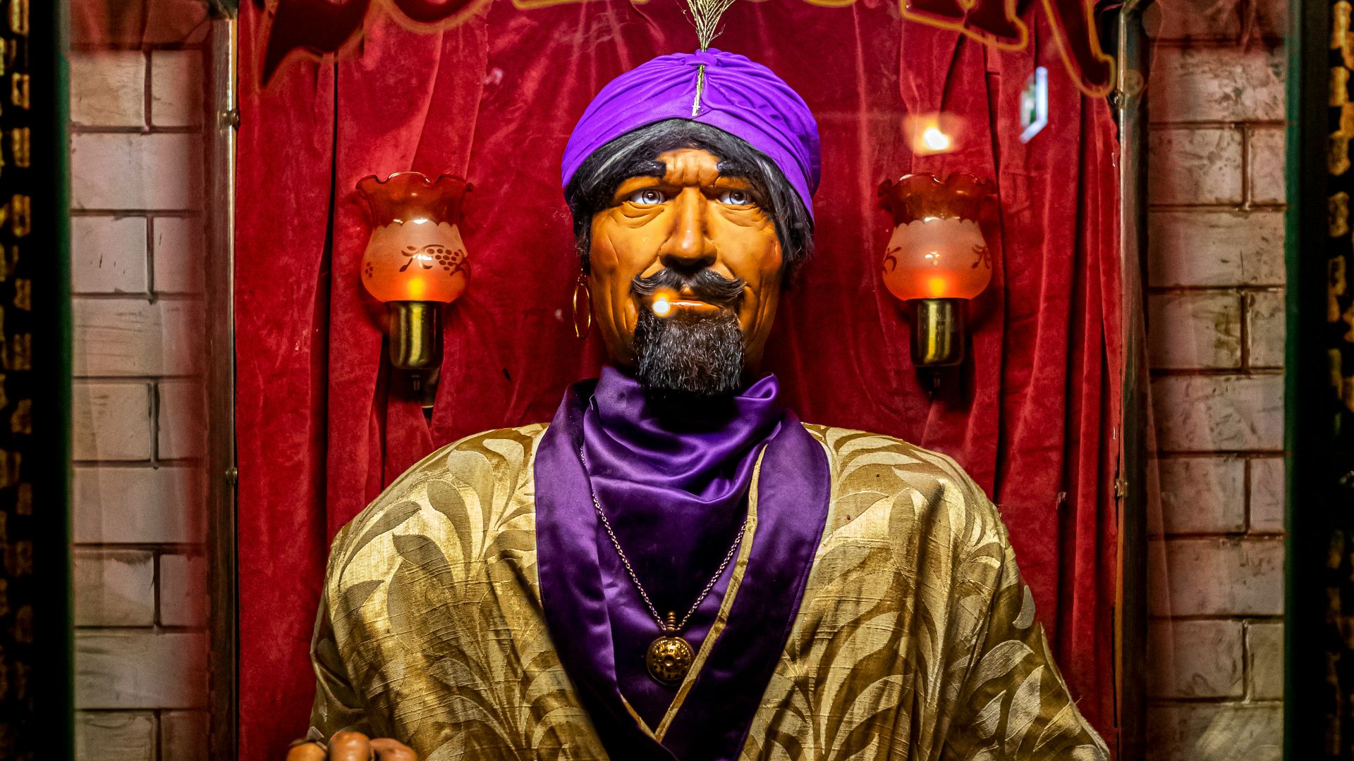 man in gold and brown robe holding black and silver dslr camera