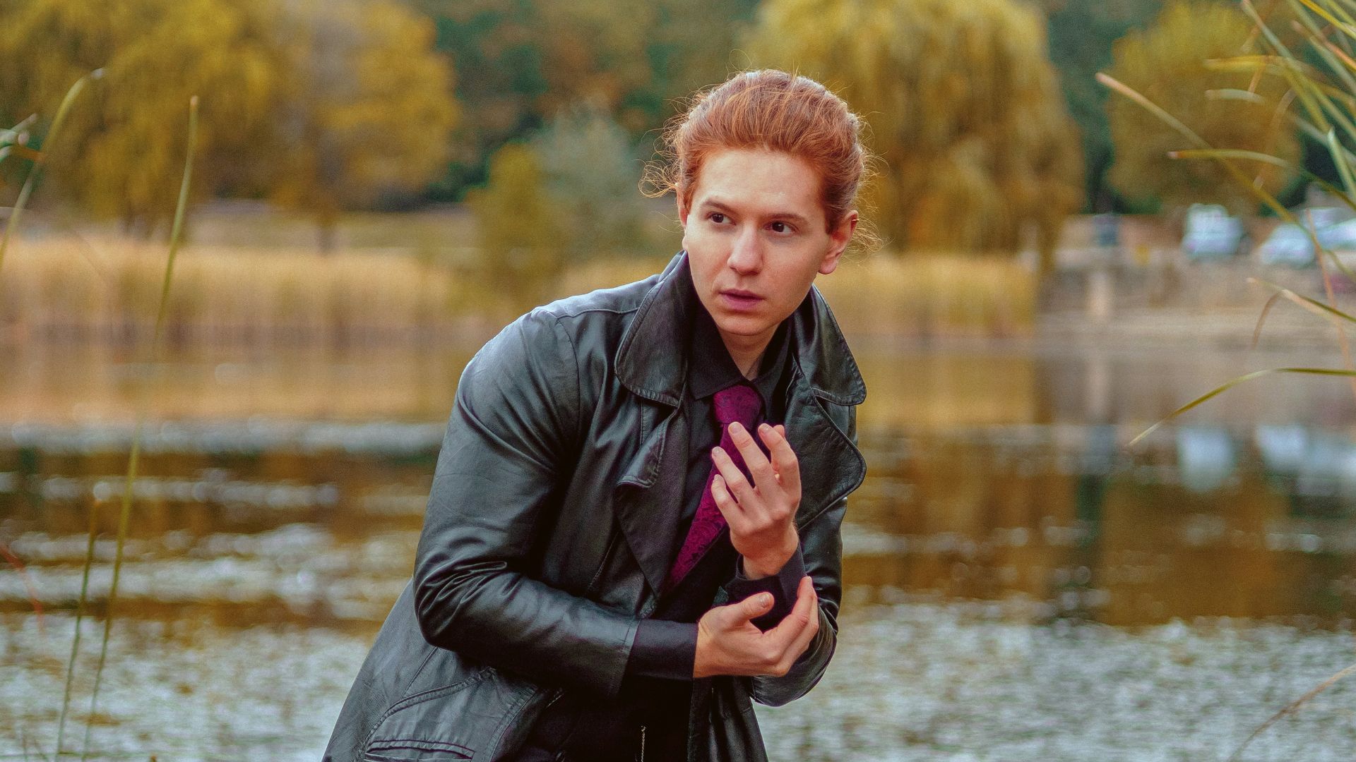 a man standing on a rock in front of a body of water