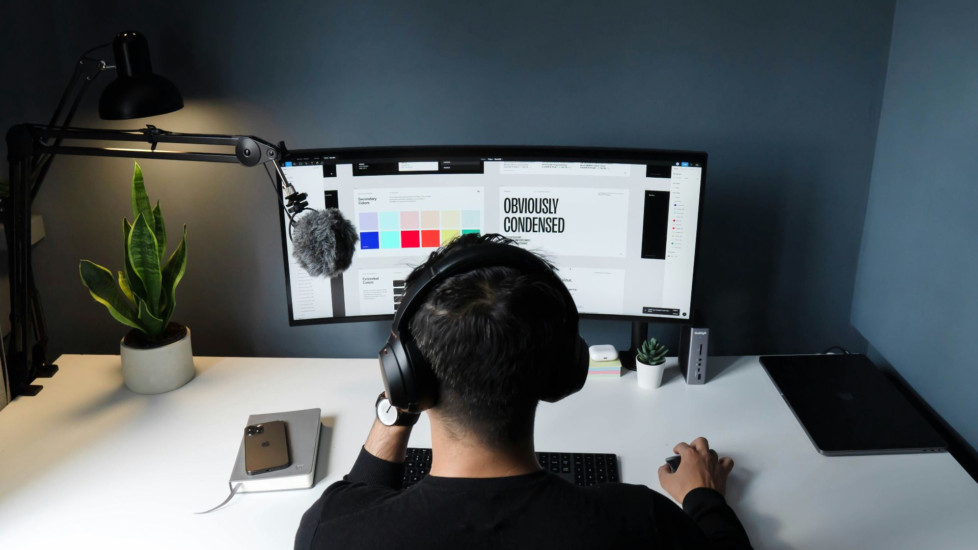 man in black shirt sitting in front of computer