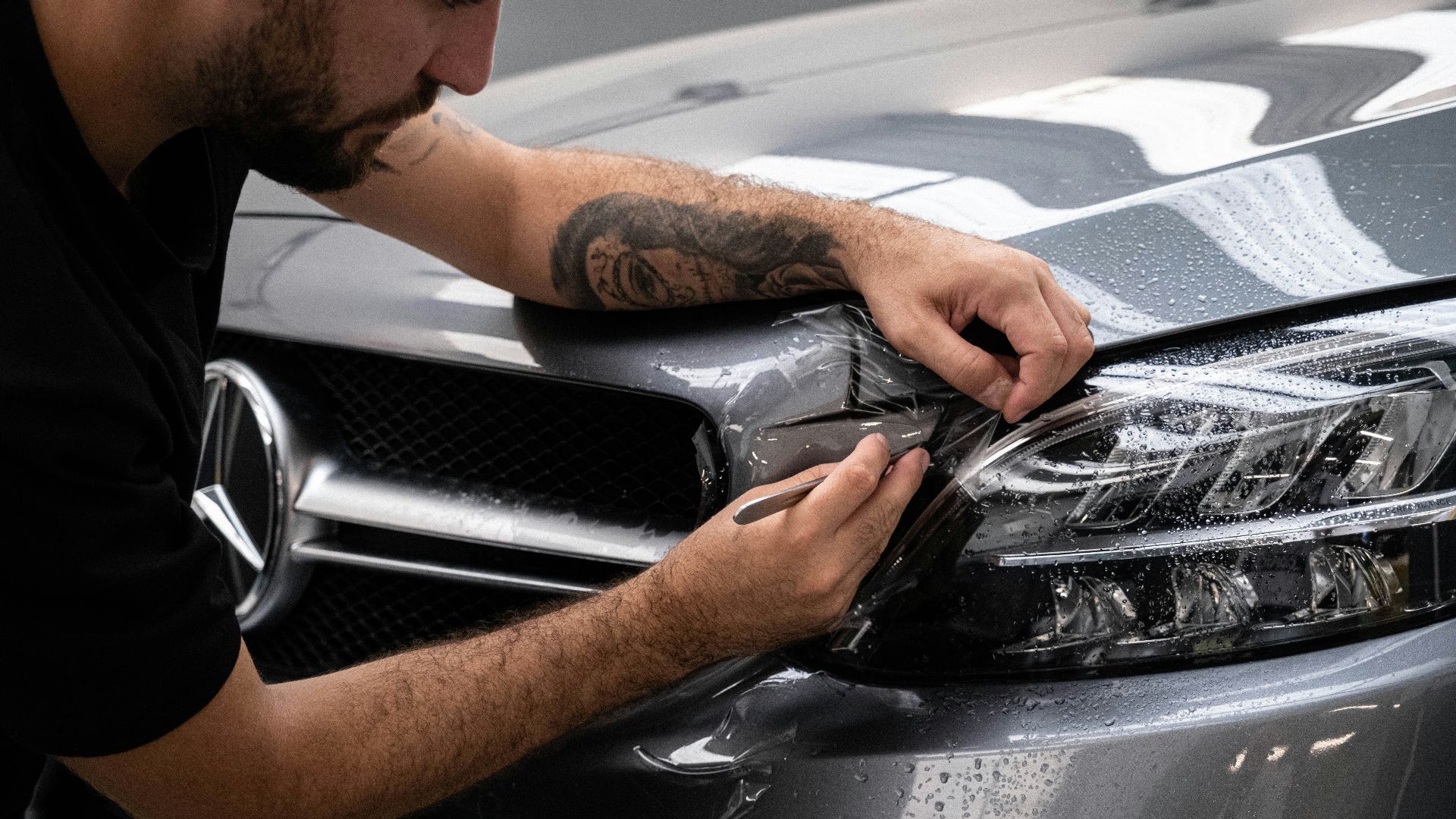 a man waxing the hood of a car