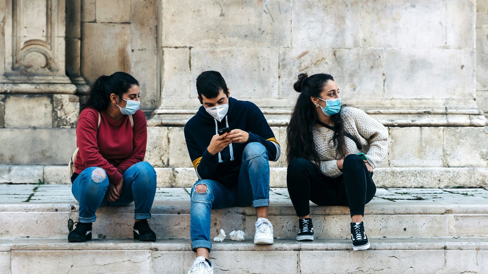 group of people sitting on concrete stairs