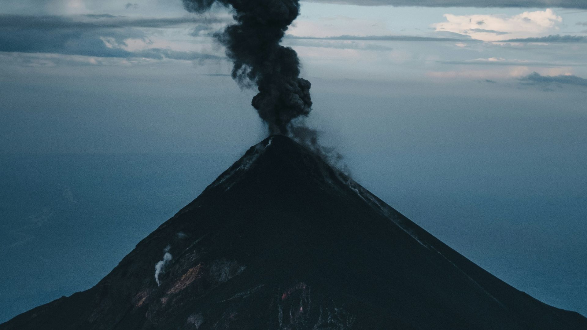 a volcano erupting with smoke