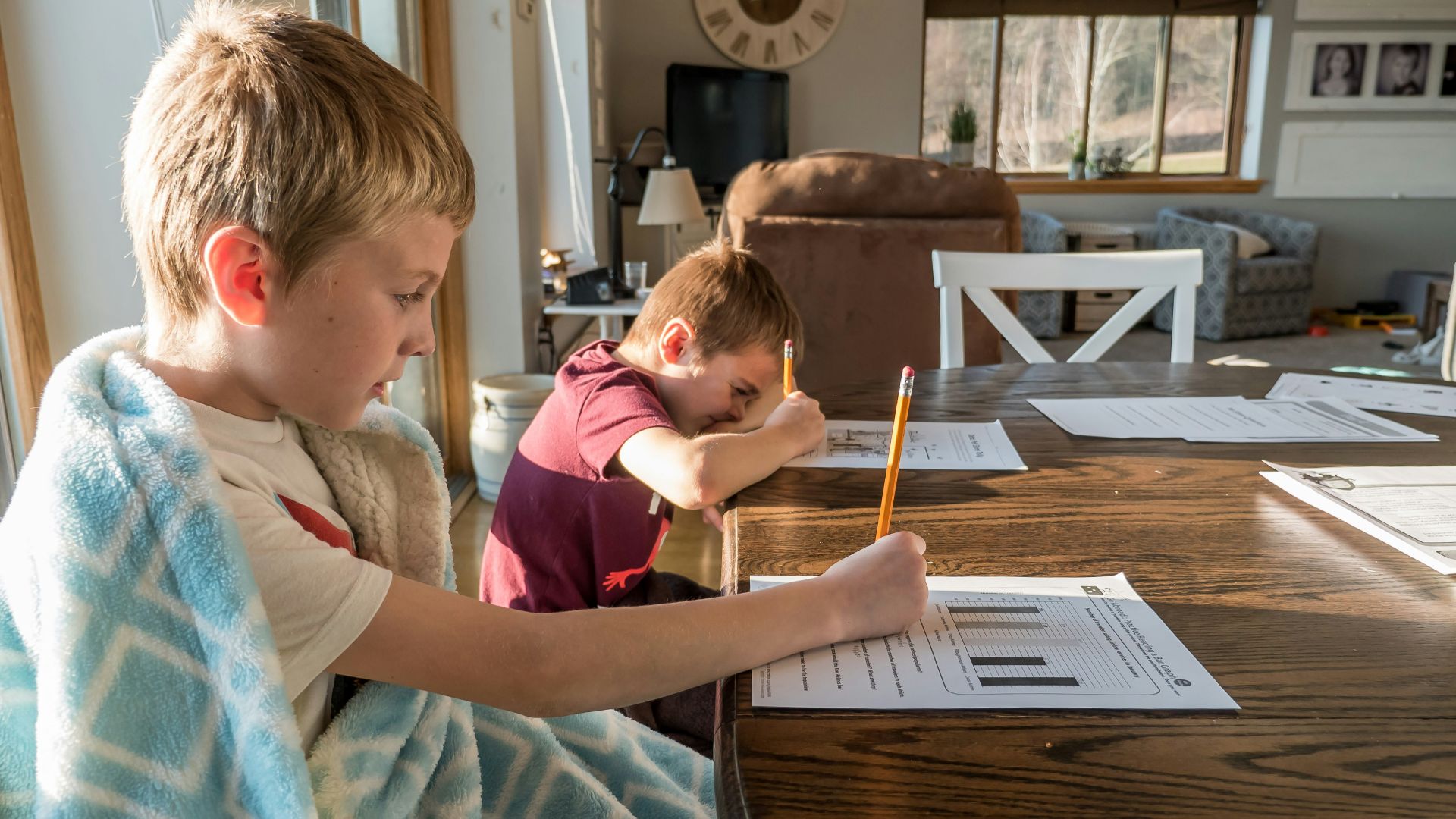 boy in gray crew neck t-shirt reading book